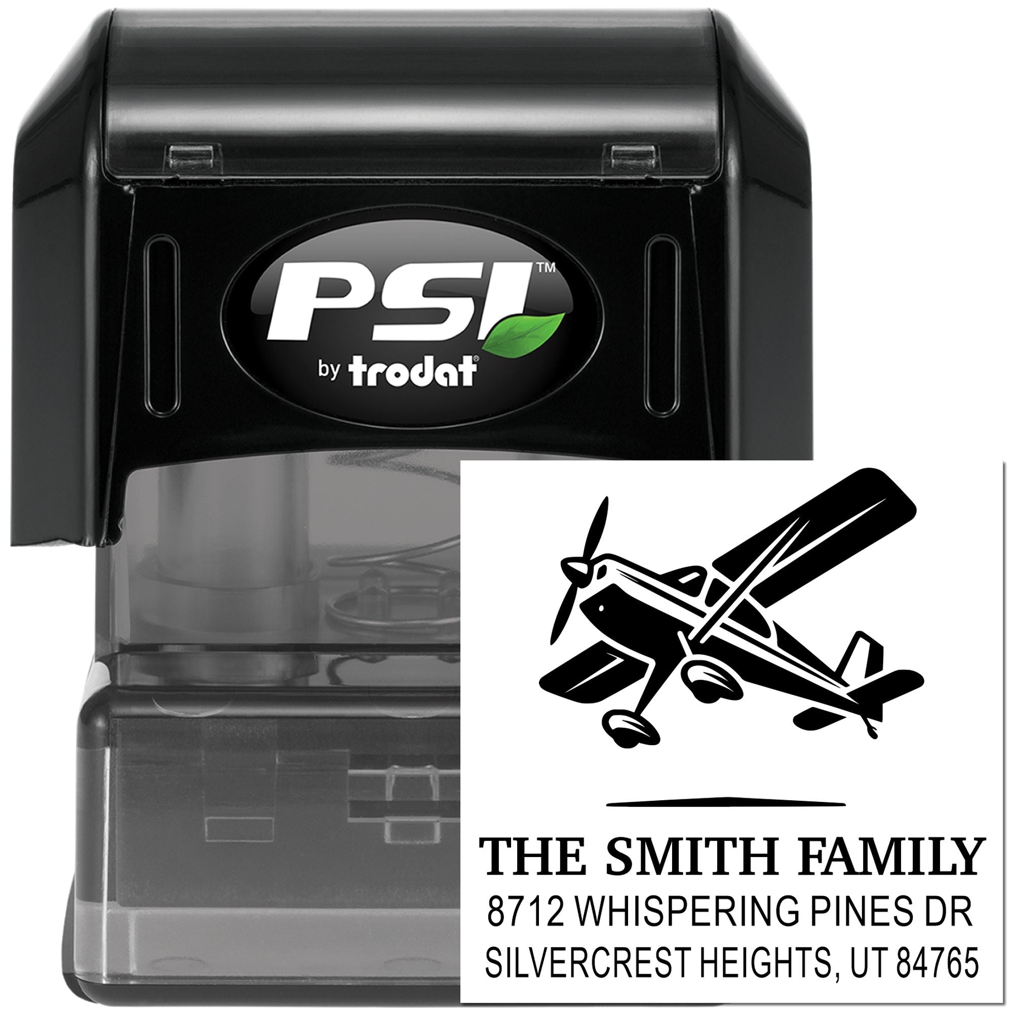 Black PSI by Trodat self-inking address stamp with airplane design and Smith family return address imprint on white background.