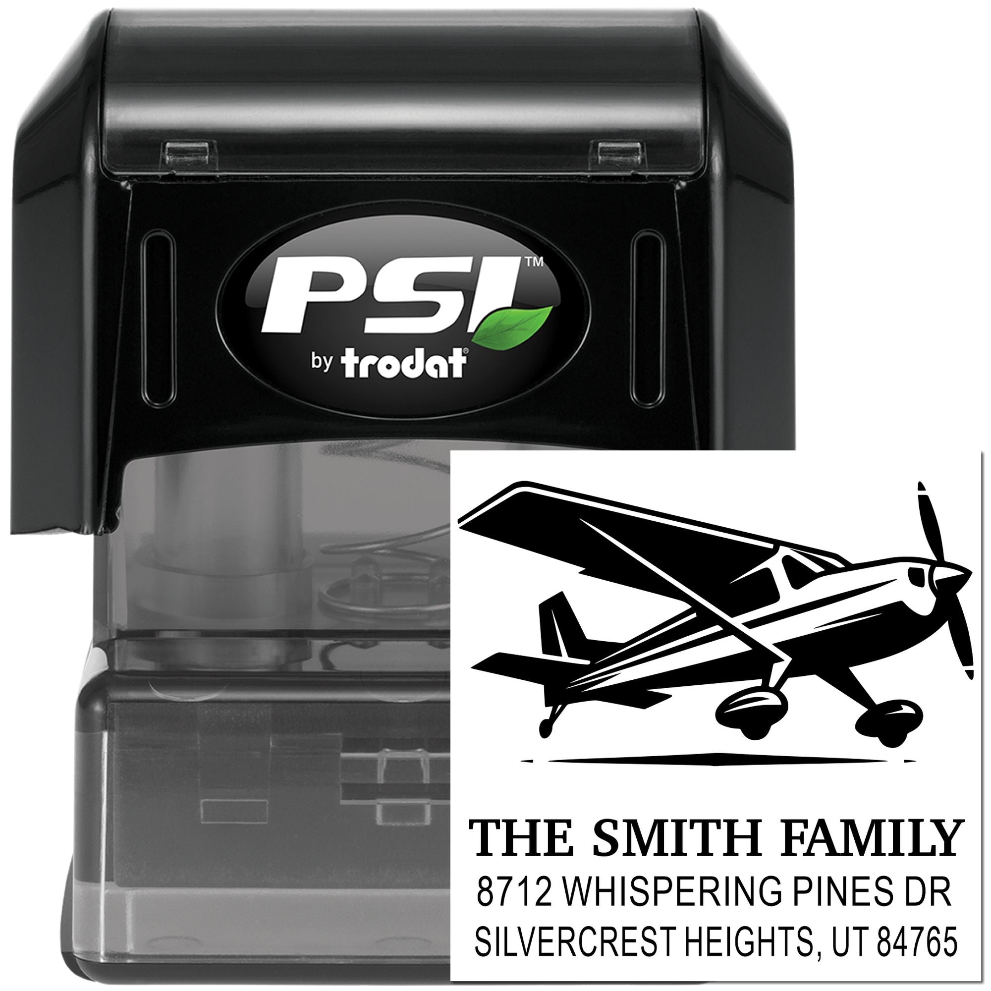 Black PSI by Trodat self-inking address stamp with airplane logo and custom family name imprint on a white background.