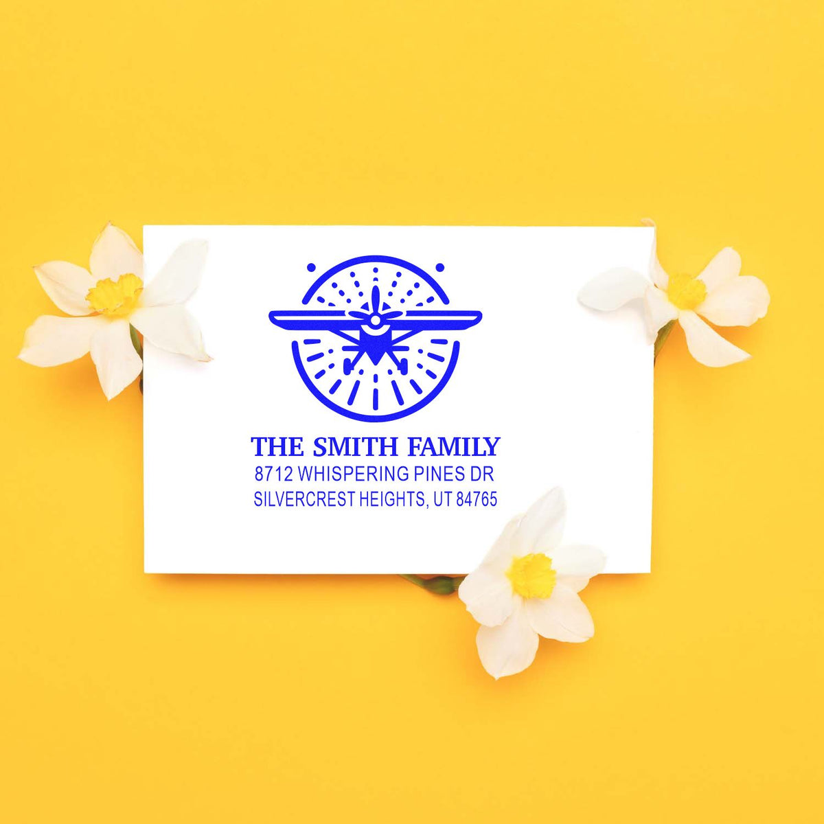 Custom blue family address stamp for The Smith Family on white card, styled with white flowers on a bright yellow background.