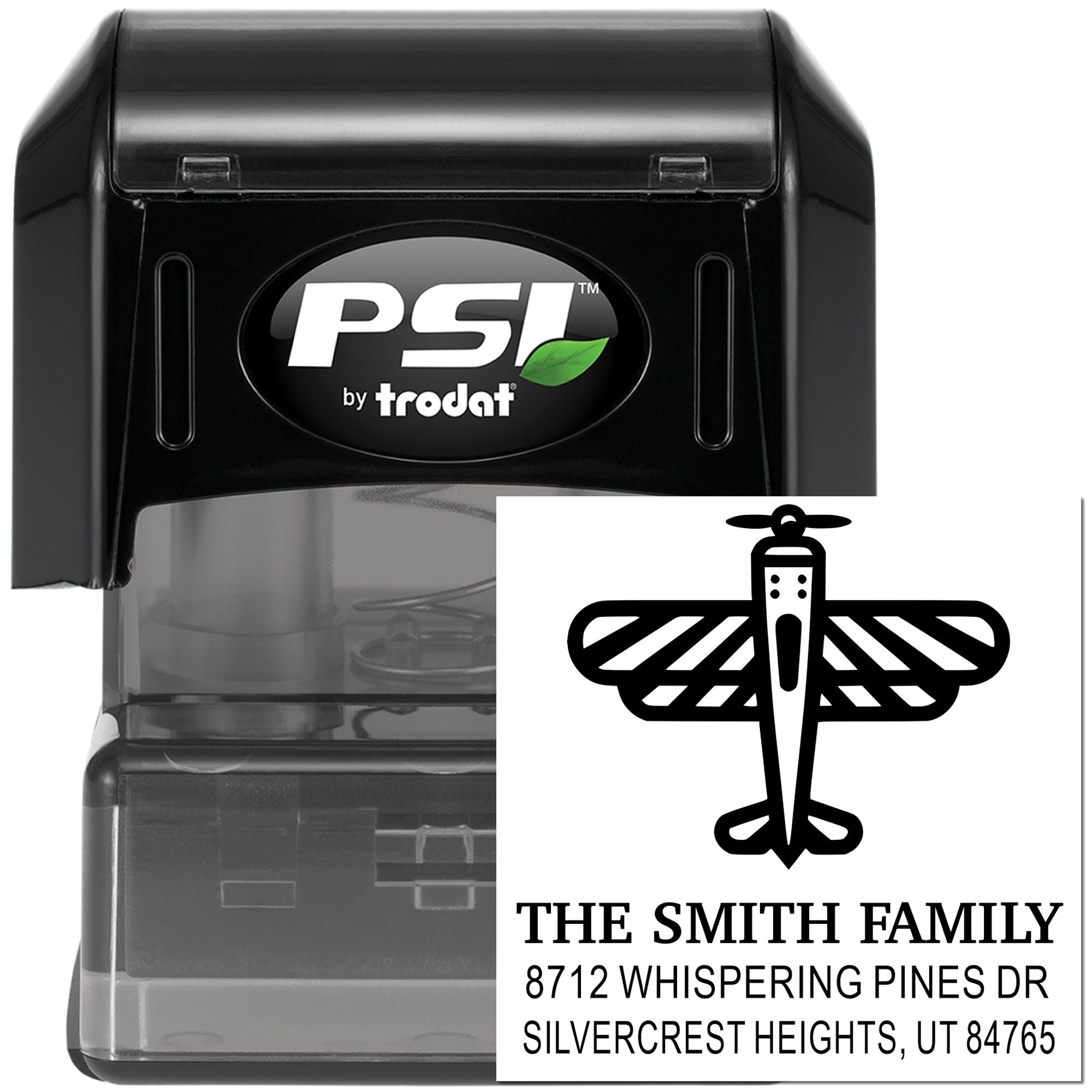Custom self-inking address stamp by PSI/Trodat with dragonfly design and Smith family address, shown on a black stamp case against a white background.
