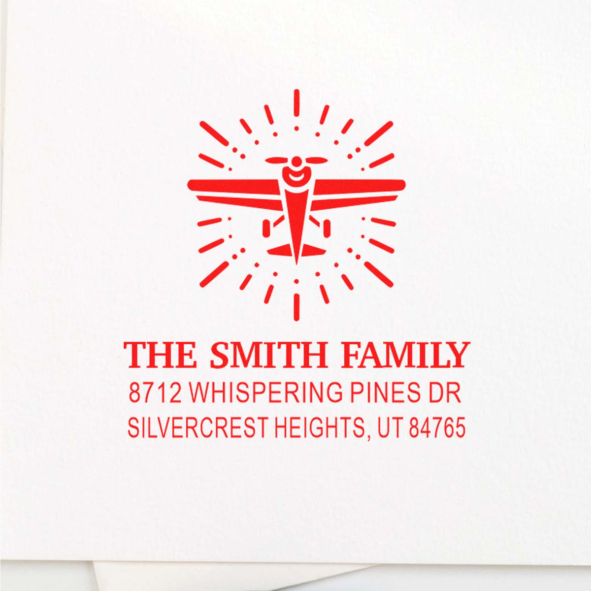 Custom red address stamp with airplane logo on white background, reading The Smith Family and Silvercrest Heights, UT address.