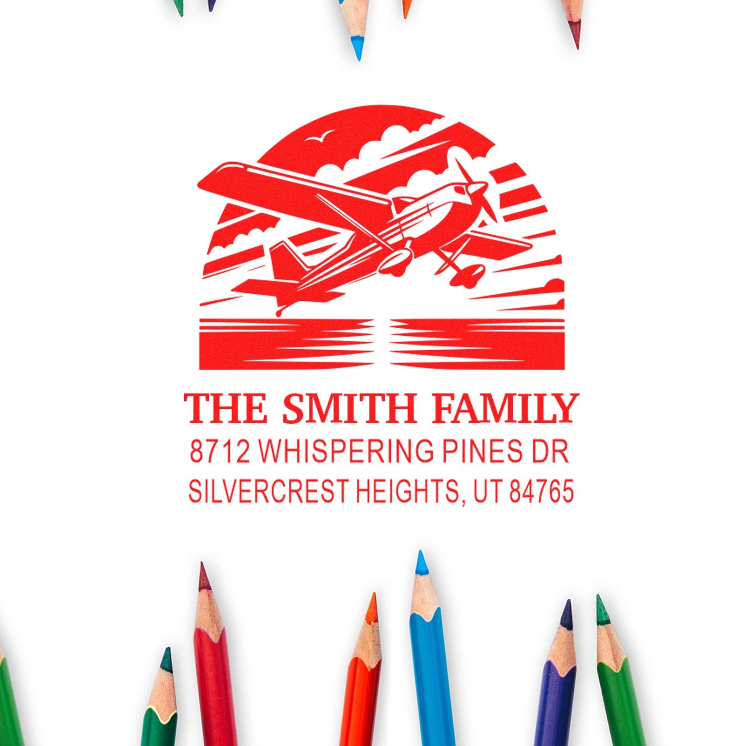 Personalized red return address stamp with airplane design for The Smith Family, on white background with colored pencils.