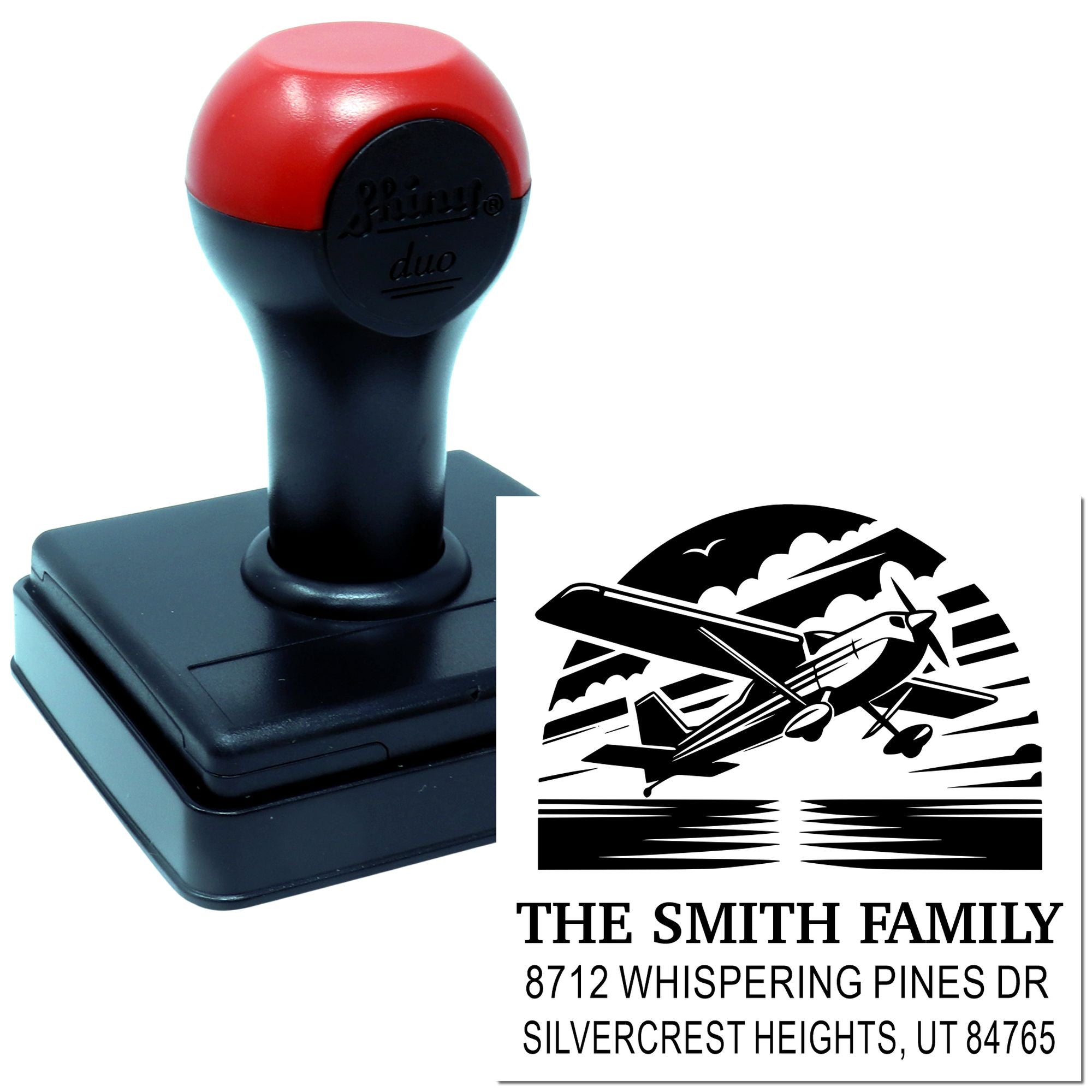 Custom self-inking address stamp with airplane logo, The Smith Family name, and Silvercrest Heights, UT address on a white background.