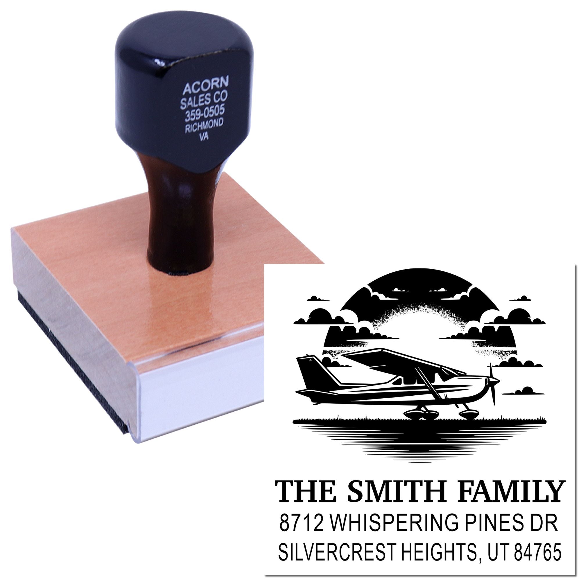 Custom self-inking address stamp with airplane silhouette, stamping a wooden block; personalized family name and Utah address on white background.