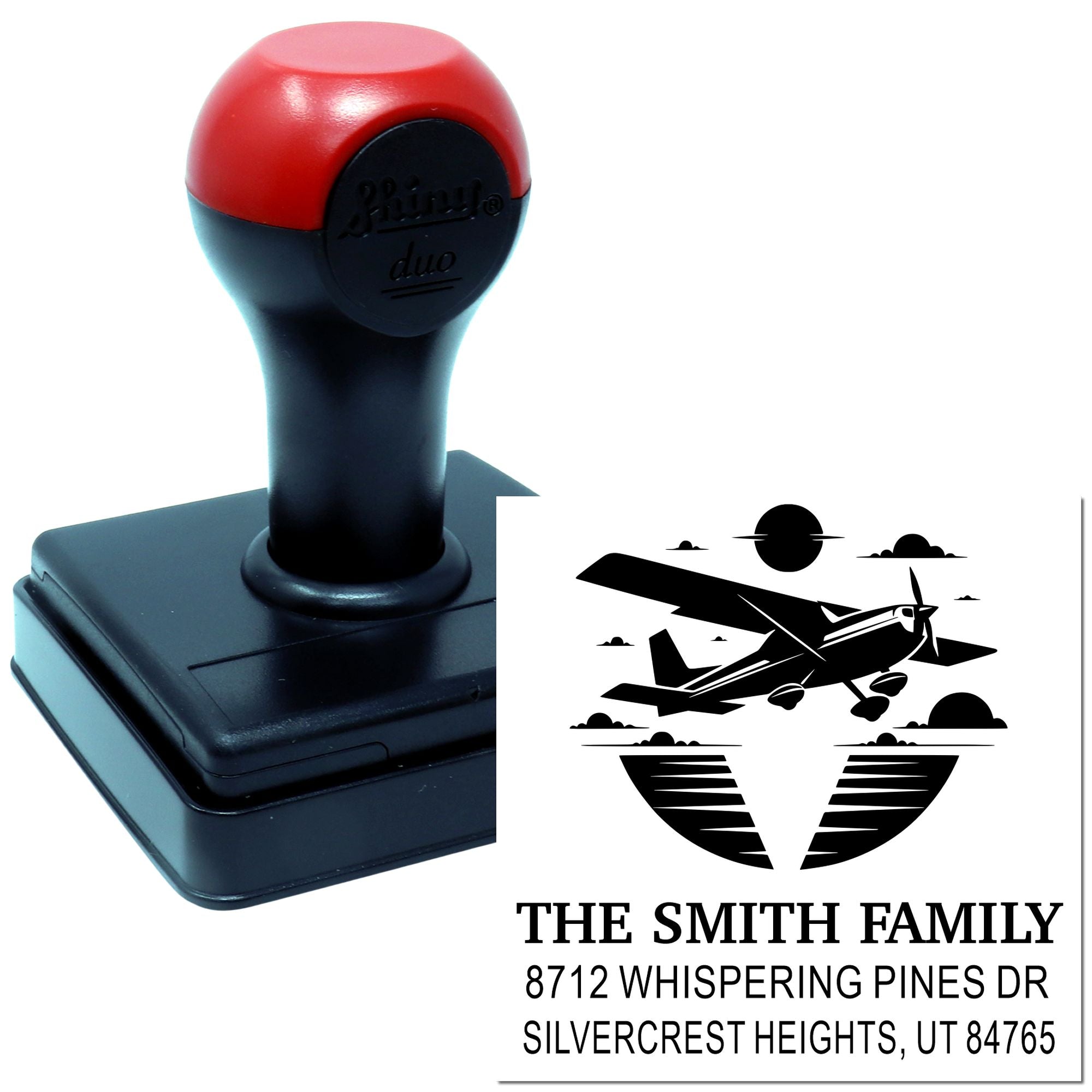Custom self-inking address stamp with airplane silhouette for The Smith Family, displaying Whispering Pines Dr, Silvercrest Heights, UT.