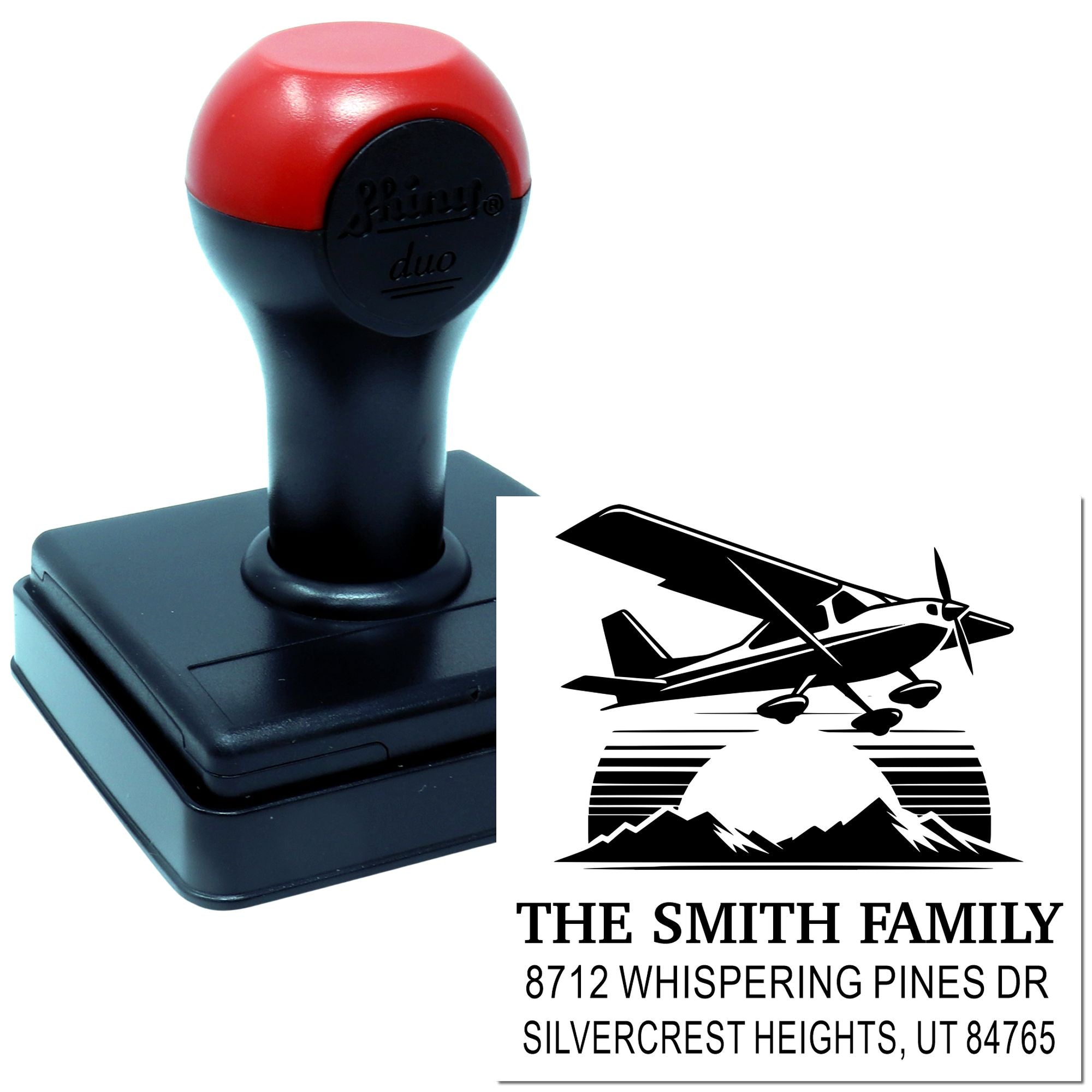 Custom self-inking address stamp with airplane design and The Smith Family return address on a white background.