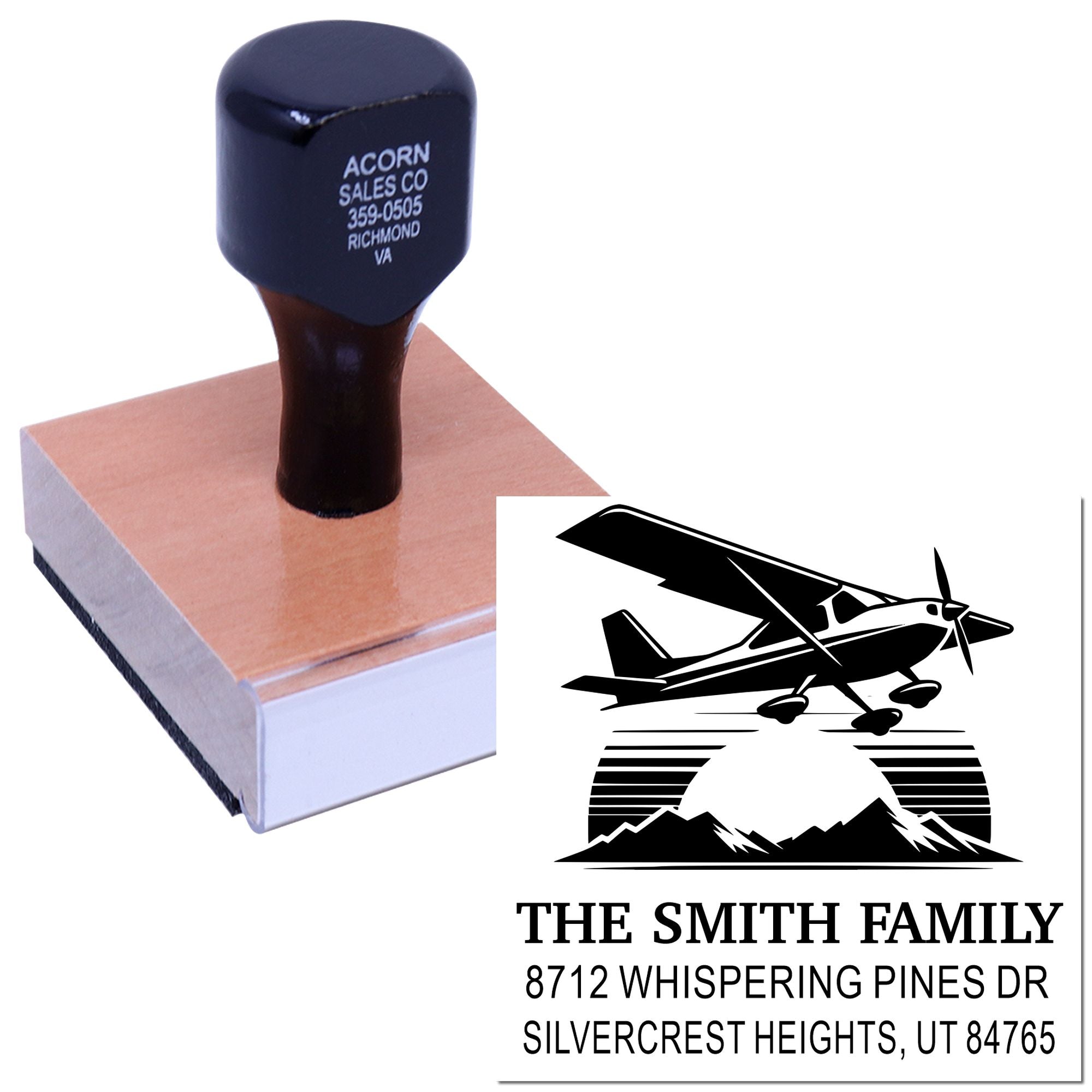 Custom return address stamp with airplane and mountain logo, self-inking block, showing The Smith Family address on a white background.
