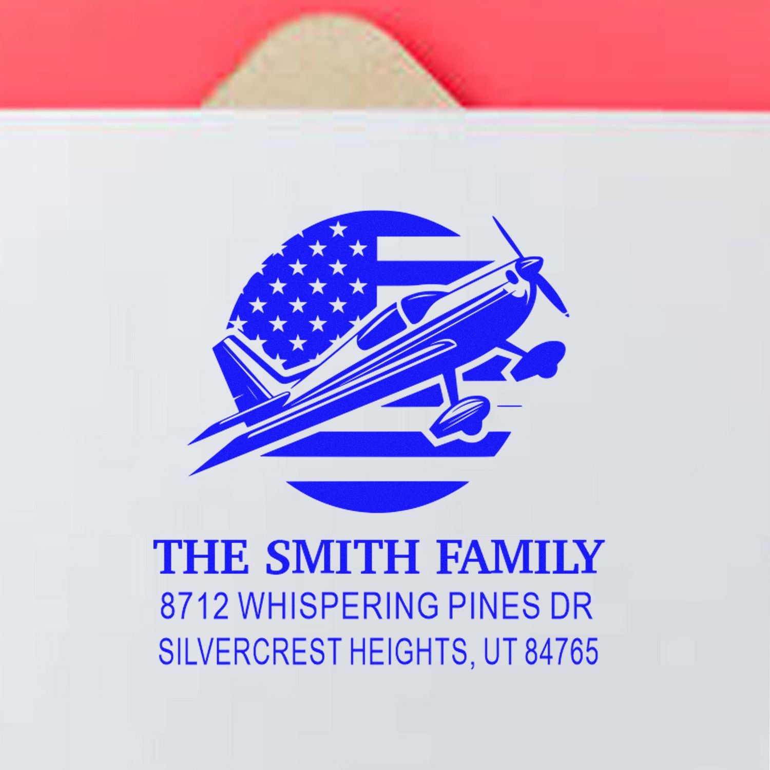 Custom return address stamp for The Smith Family with blue airplane and US flag design, showing 8712 Whispering Pines Dr, Silvercrest Heights, UT 84765.
