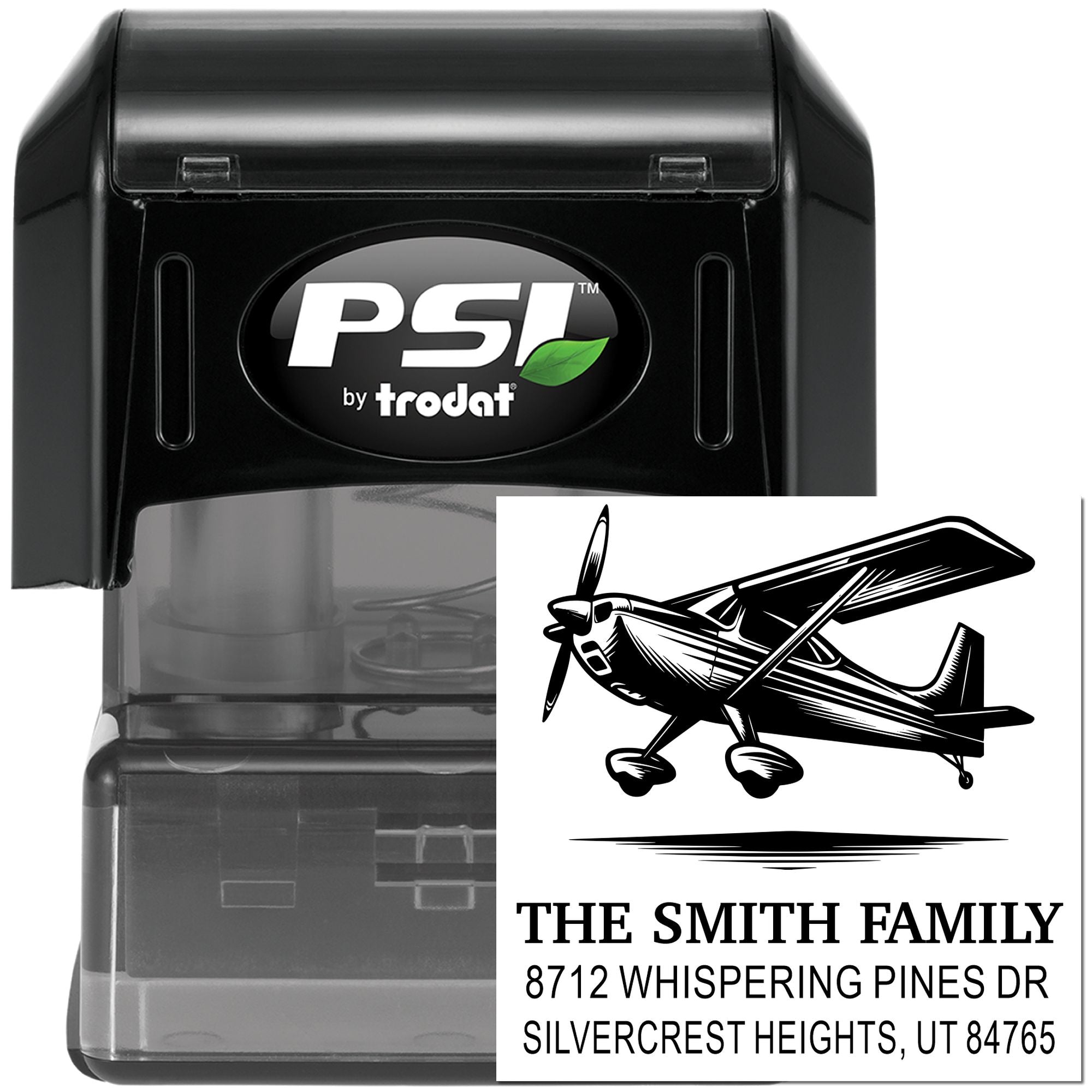 PSI by Trodat self-inking address stamp with airplane design, showing The Smith Family return-address impression in a clear black stamp case on white background.
