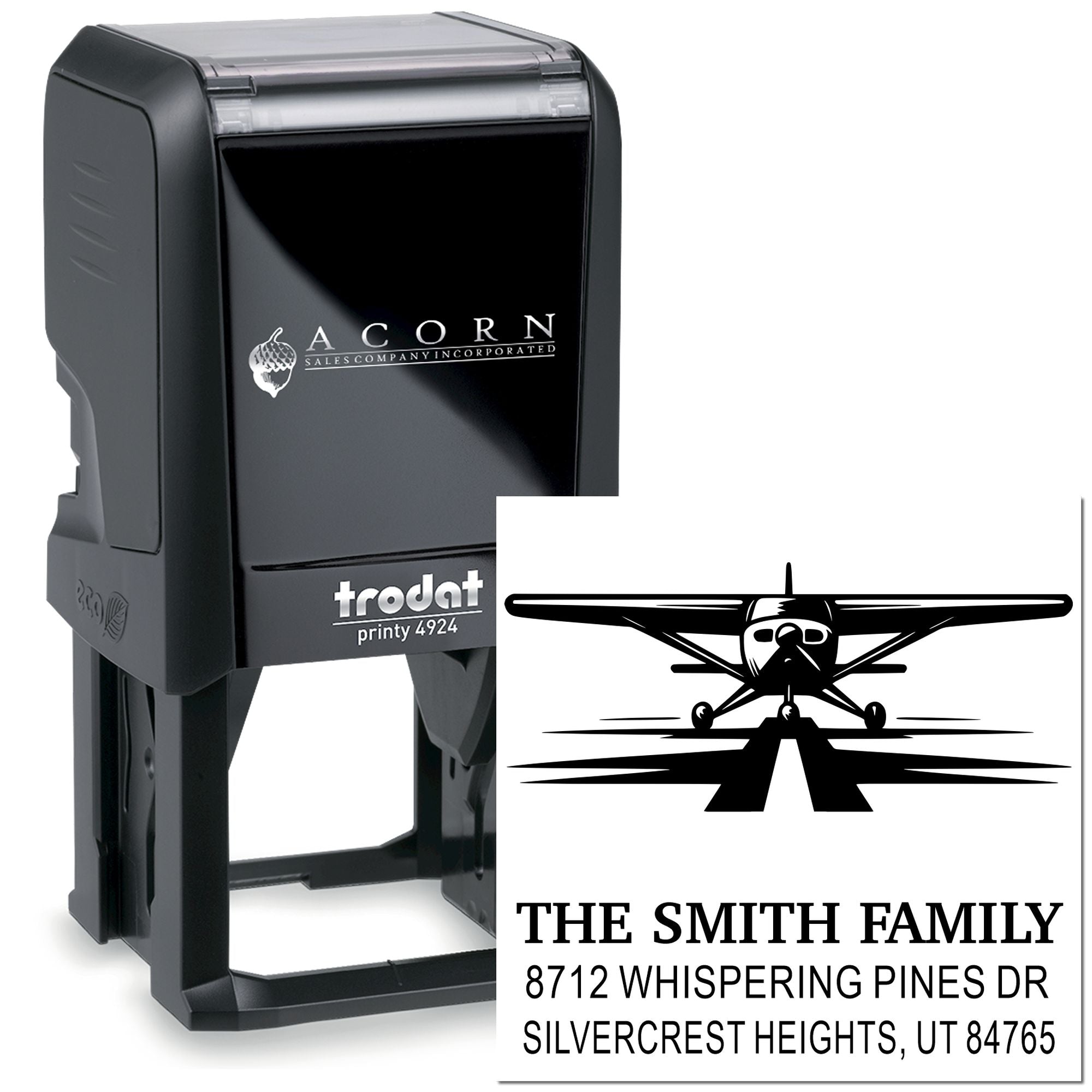 Custom self-inking Trodat stamp with airplane design and The Smith Family return address imprint on a white background.