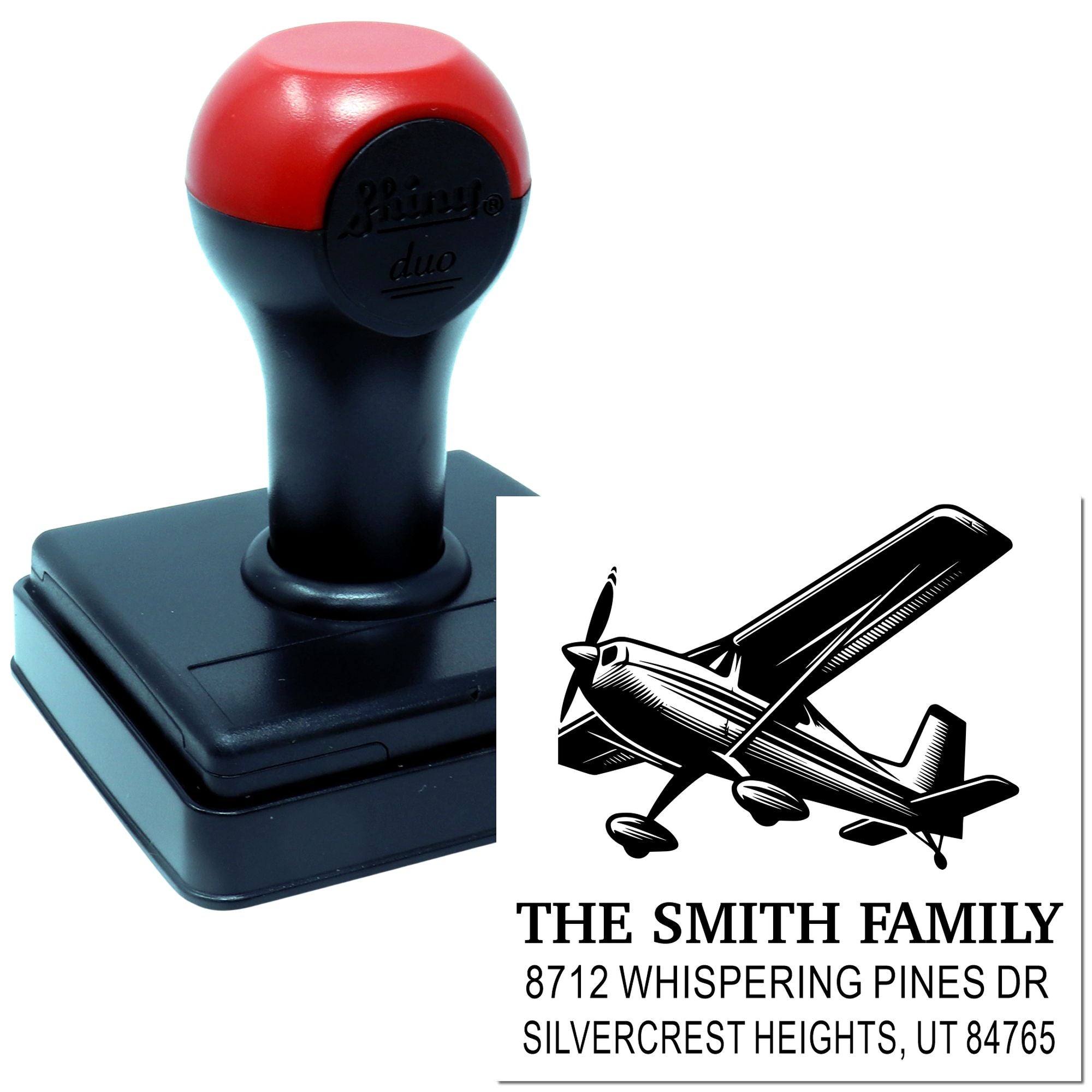 Custom self-inking address stamp with airplane design and Smith family return address on a white background product mockup.