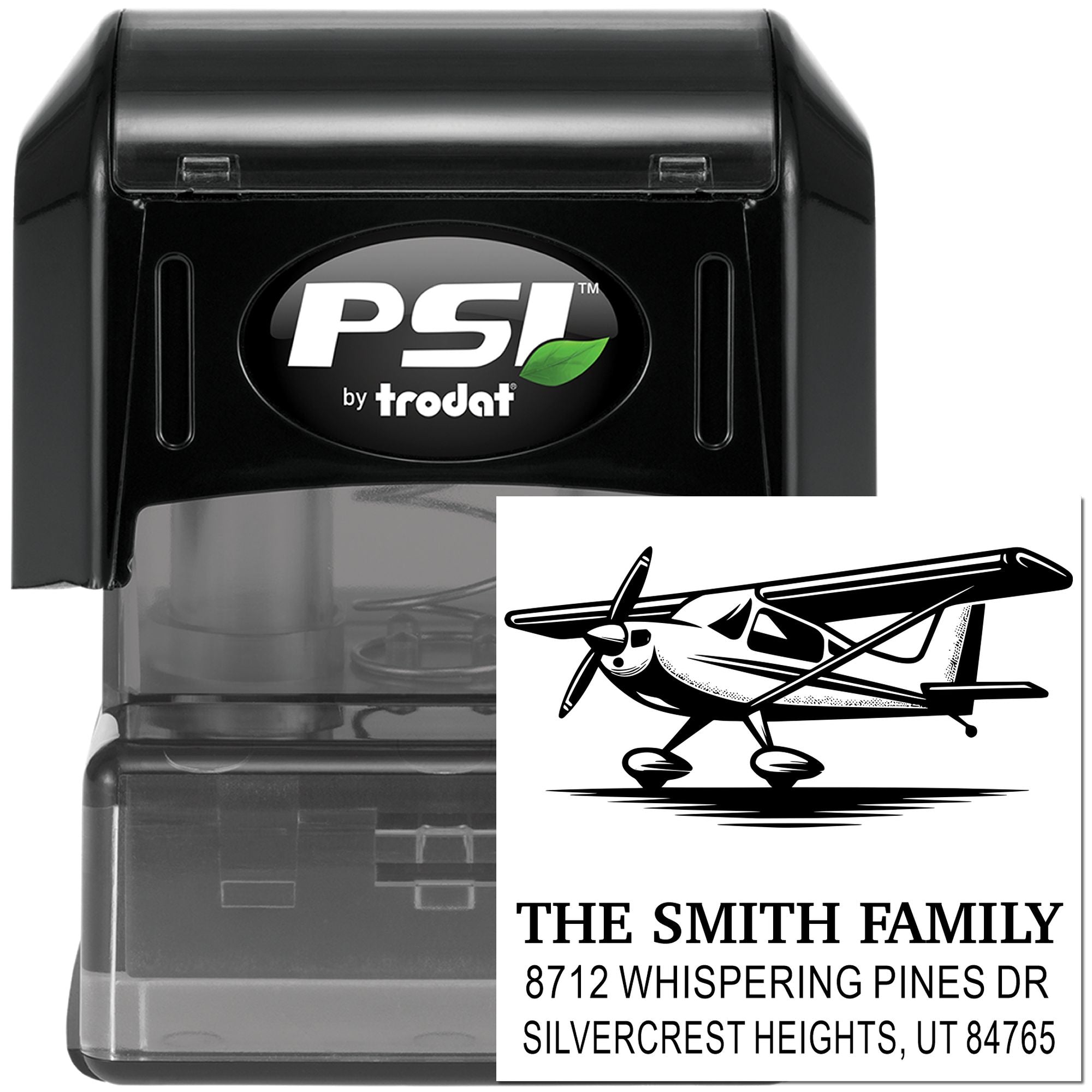 PSI by Trodat self-inking address stamp with airplane design and custom family address imprint on a white background.