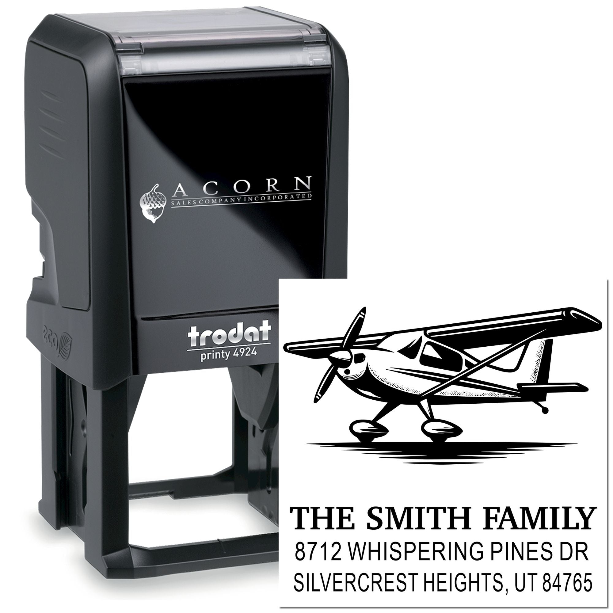 Custom self-inking address stamp with airplane graphic and The Smith Family return address on a black Trodat stamp on white background.