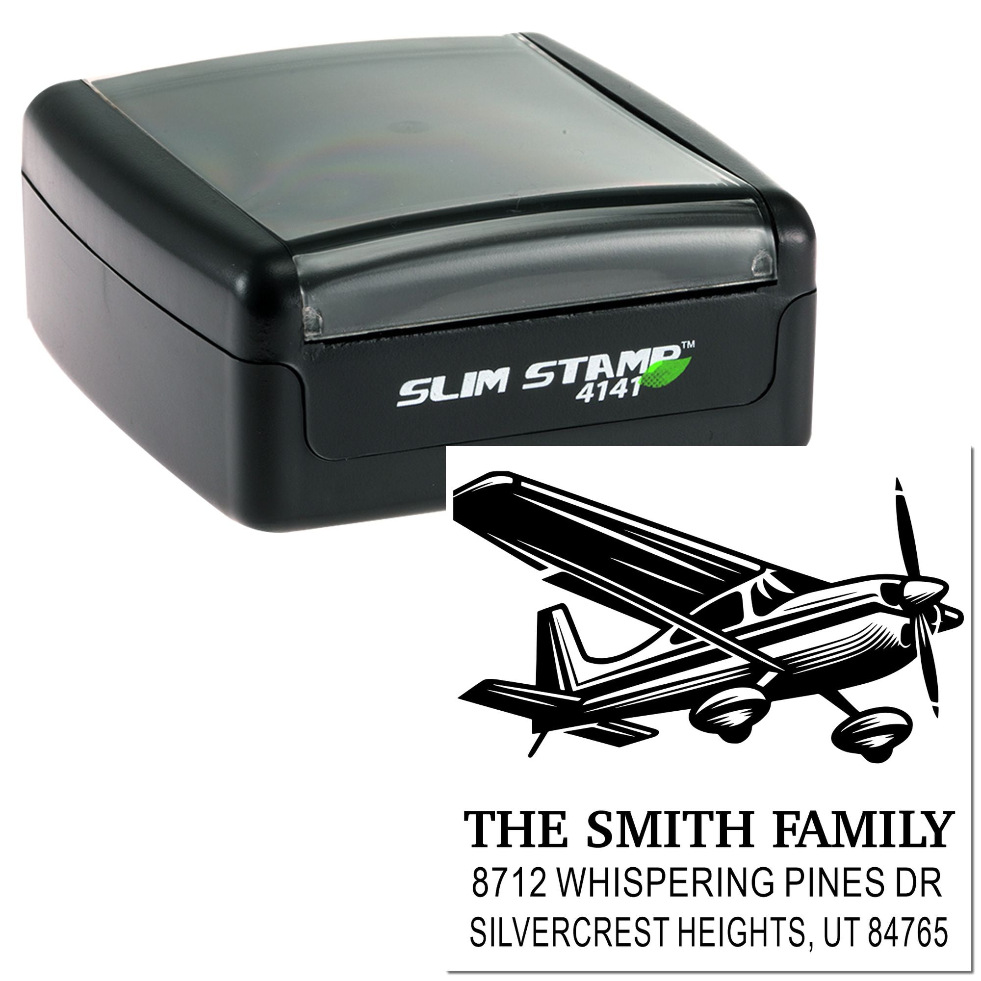 Slim Stamp 4141 self-inking address stamp with airplane graphic and personalized family name and home address imprint on white background.
