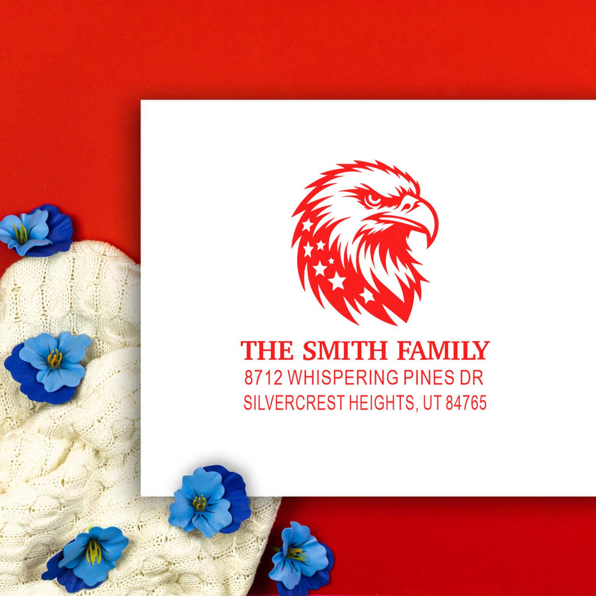 Personalized eagle address stamp with The Smith Family name and Utah address, styled on a red background with blue flowers and knit fabric.