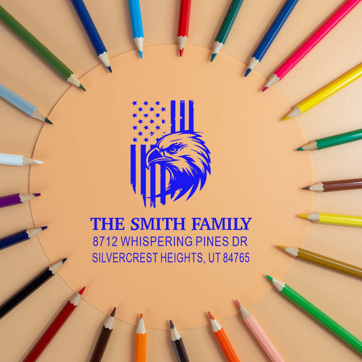 Custom family address stamp with eagle and American flag, surrounded by colorful pencils on a tan background.