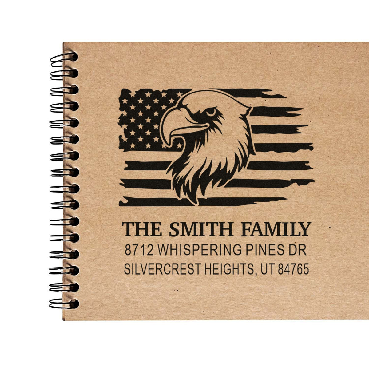 Custom family address stamp with bald eagle and American flag design on kraft notebook cover, showing The Smith Family address in Silvercrest Heights, UT.