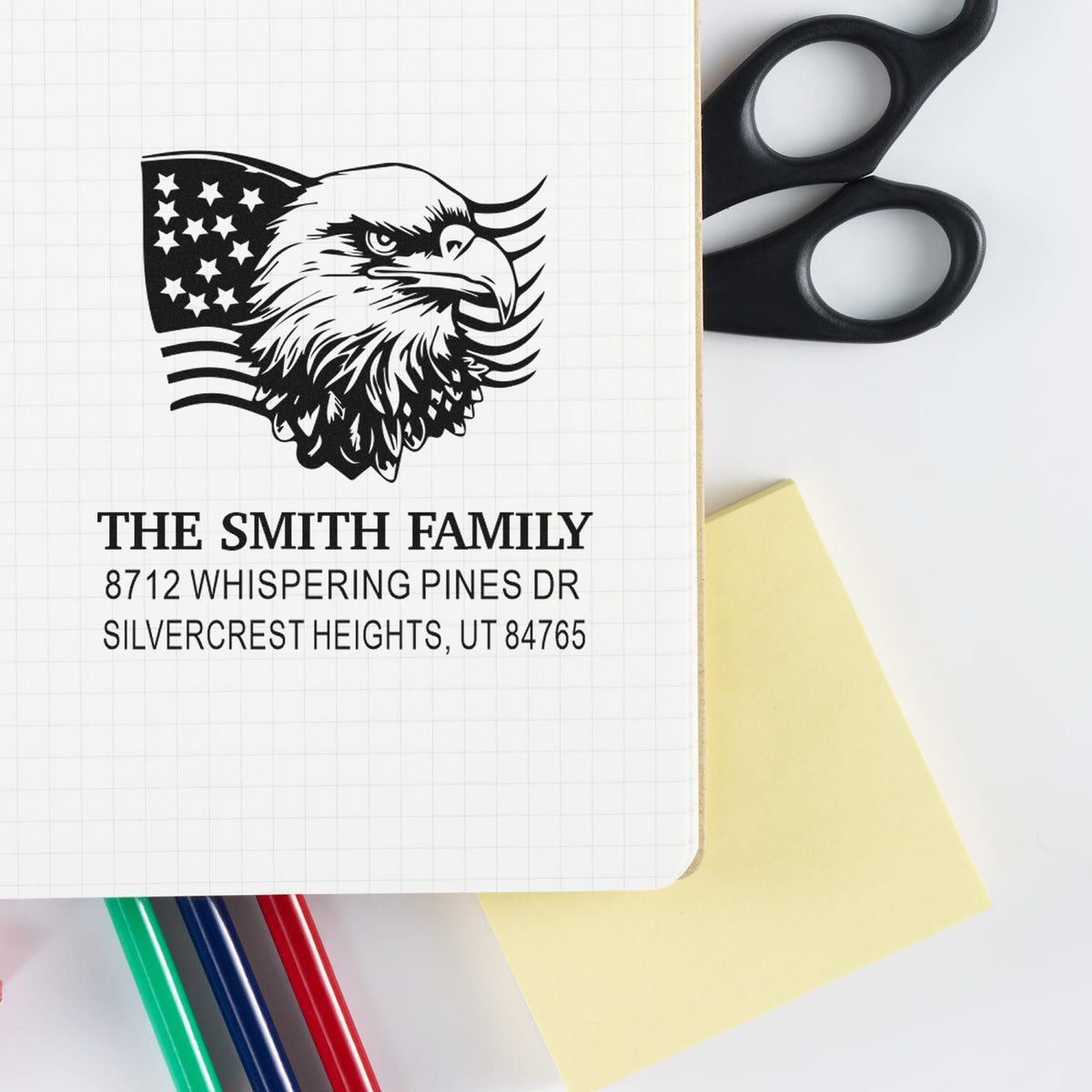 Custom family address rubber stamp with patriotic eagle and American flag design, showing The Smith Family name and mailing address on paper.