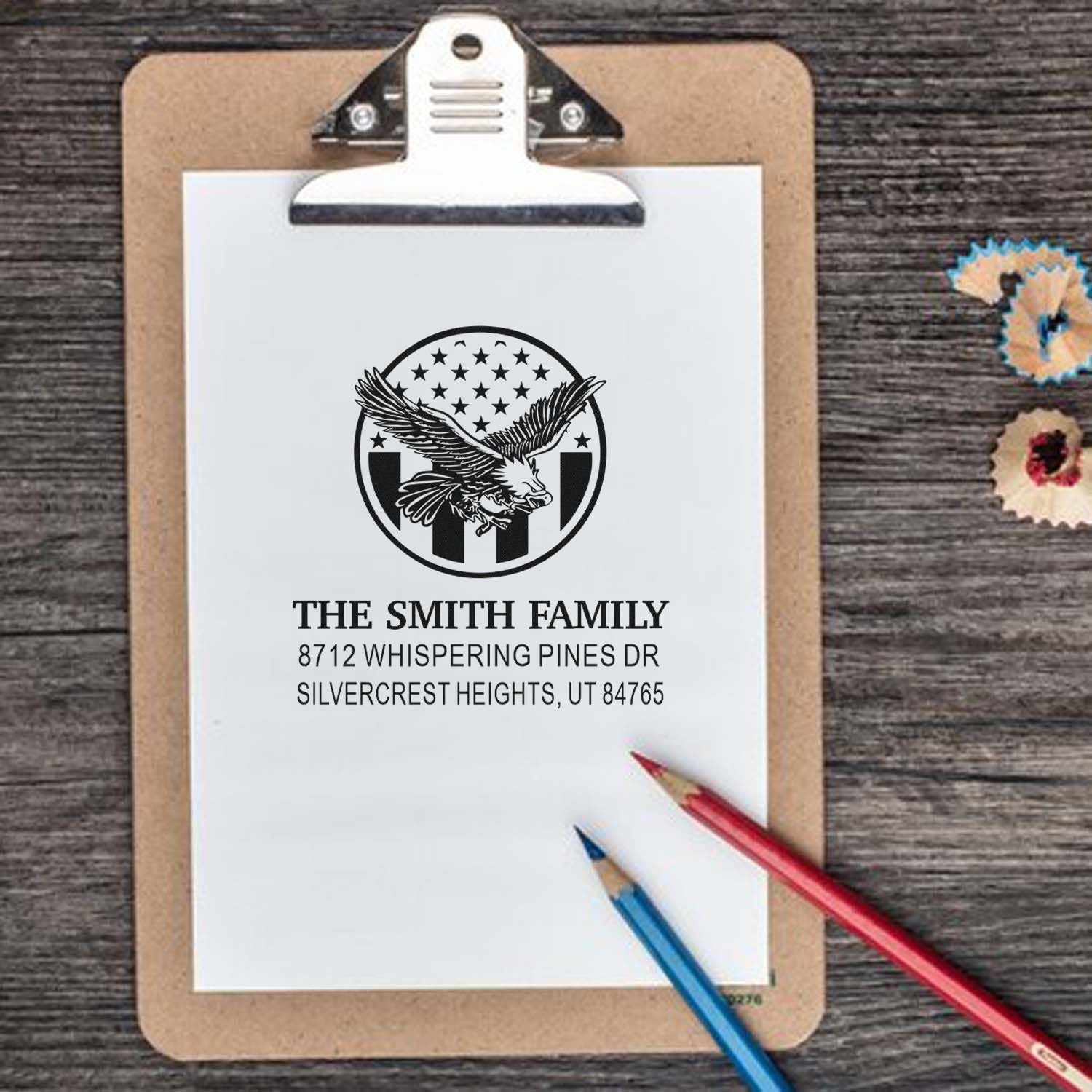 Custom family return address rubber stamp with eagle and American flag design, featuring Smith family name and Utah address on a clipboard.
