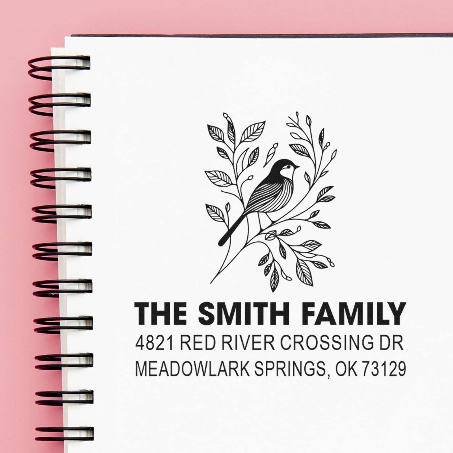 Custom return address rubber stamp with floral bird design, personalized family name, street address, city, state and ZIP for envelopes and mail.