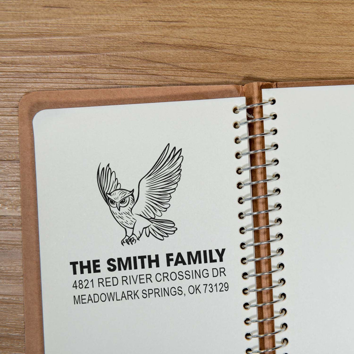 Personalized owl return address rubber stamp imprint on a spiral notebook cover, featuring The Smith Family name and Meadowlark Springs, OK address
