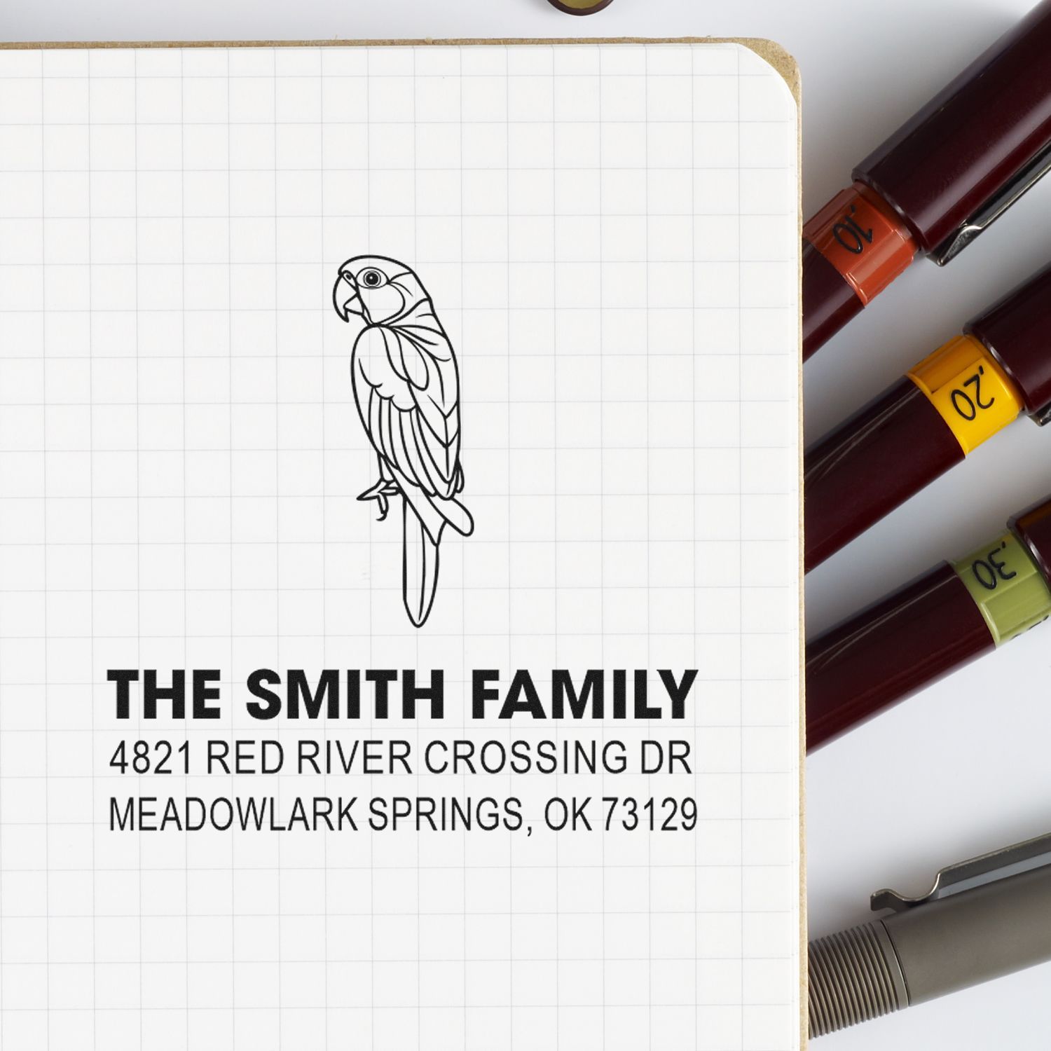 Custom self-inking rubber address stamp with parrot design for The Smith Family, 4821 Red River Crossing Dr, Meadowlark Springs, OK 73129