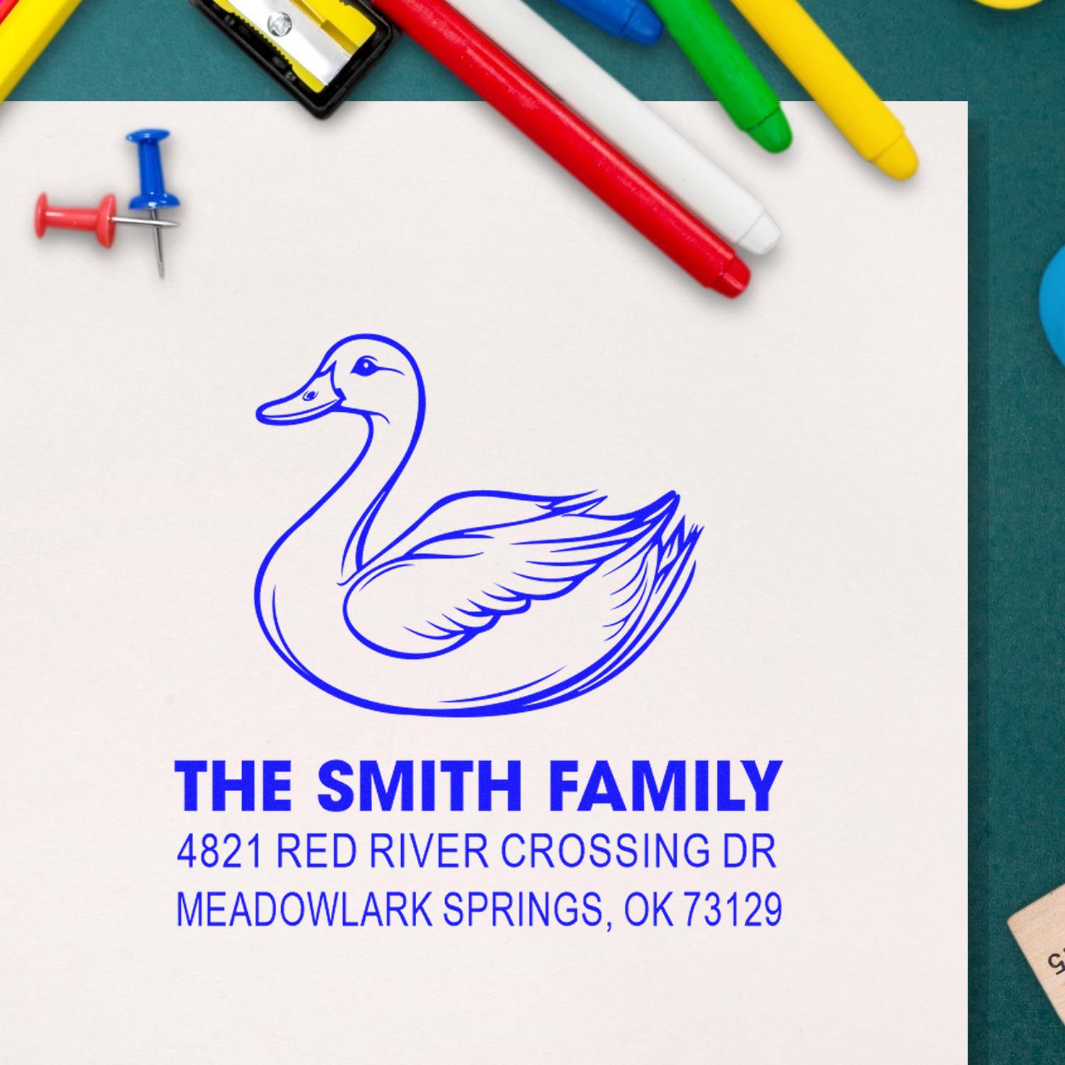 Custom rubber stamp with duck logo, The Smith Family name, and return address, creating a bold blue personalized imprint for mail, stationery, and crafts.