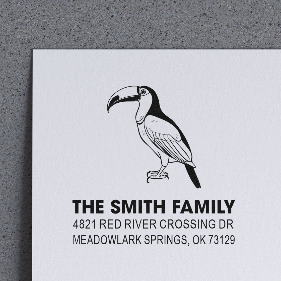 Custom return address rubber stamp with toucan illustration, The Smith Family name, and Meadowlark Springs, OK 73129 mailing address design.