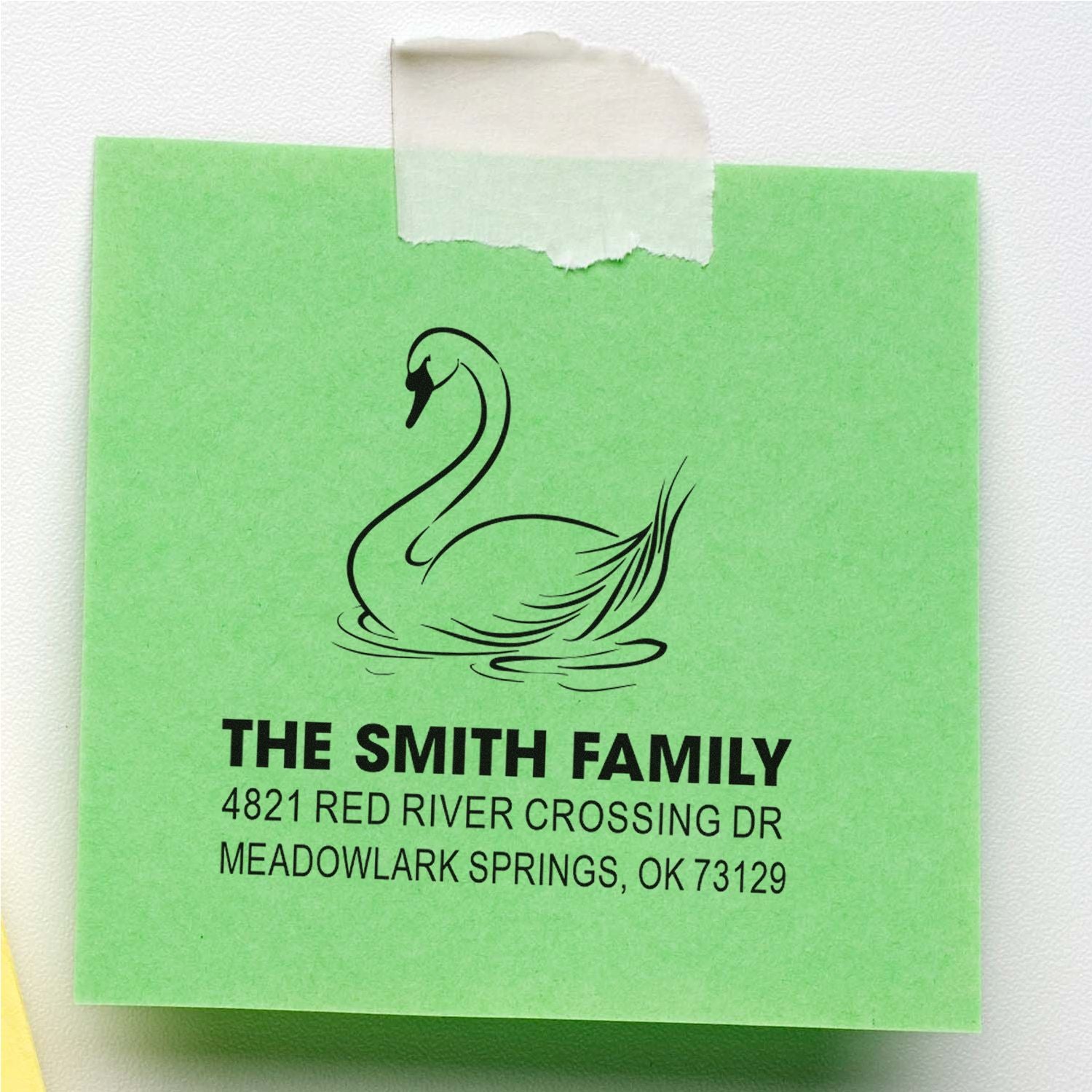 Custom return address rubber stamp with swan design for The Smith Family, featuring name and Meadowlark Springs, OK address on green paper.