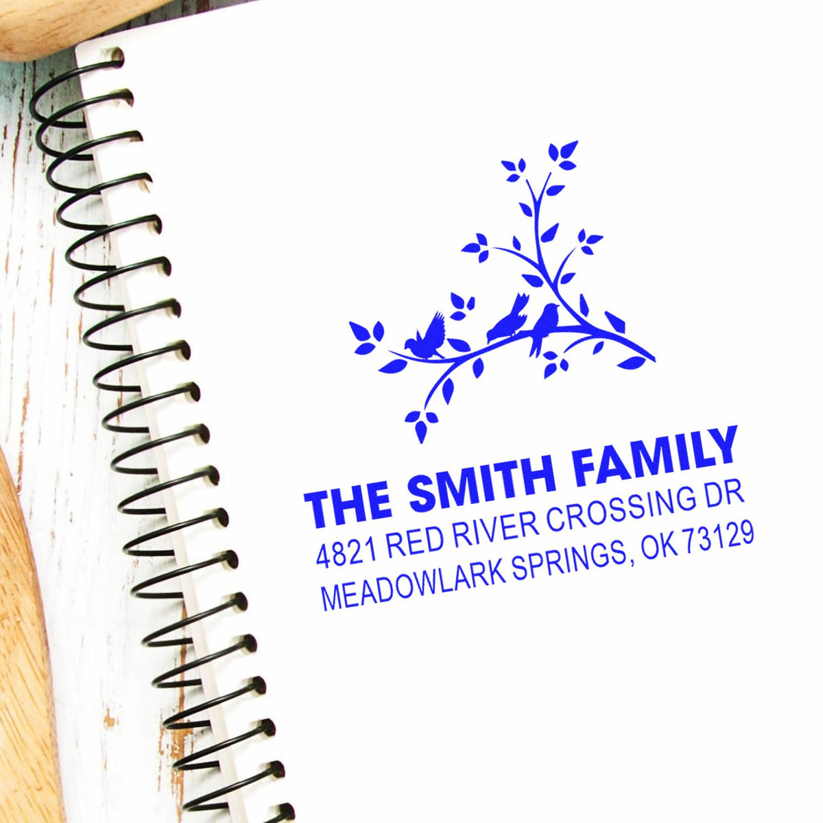 Custom family return address rubber stamp with bird and branch design, featuring The Smith Family and Meadowlark Springs, OK address in blue.