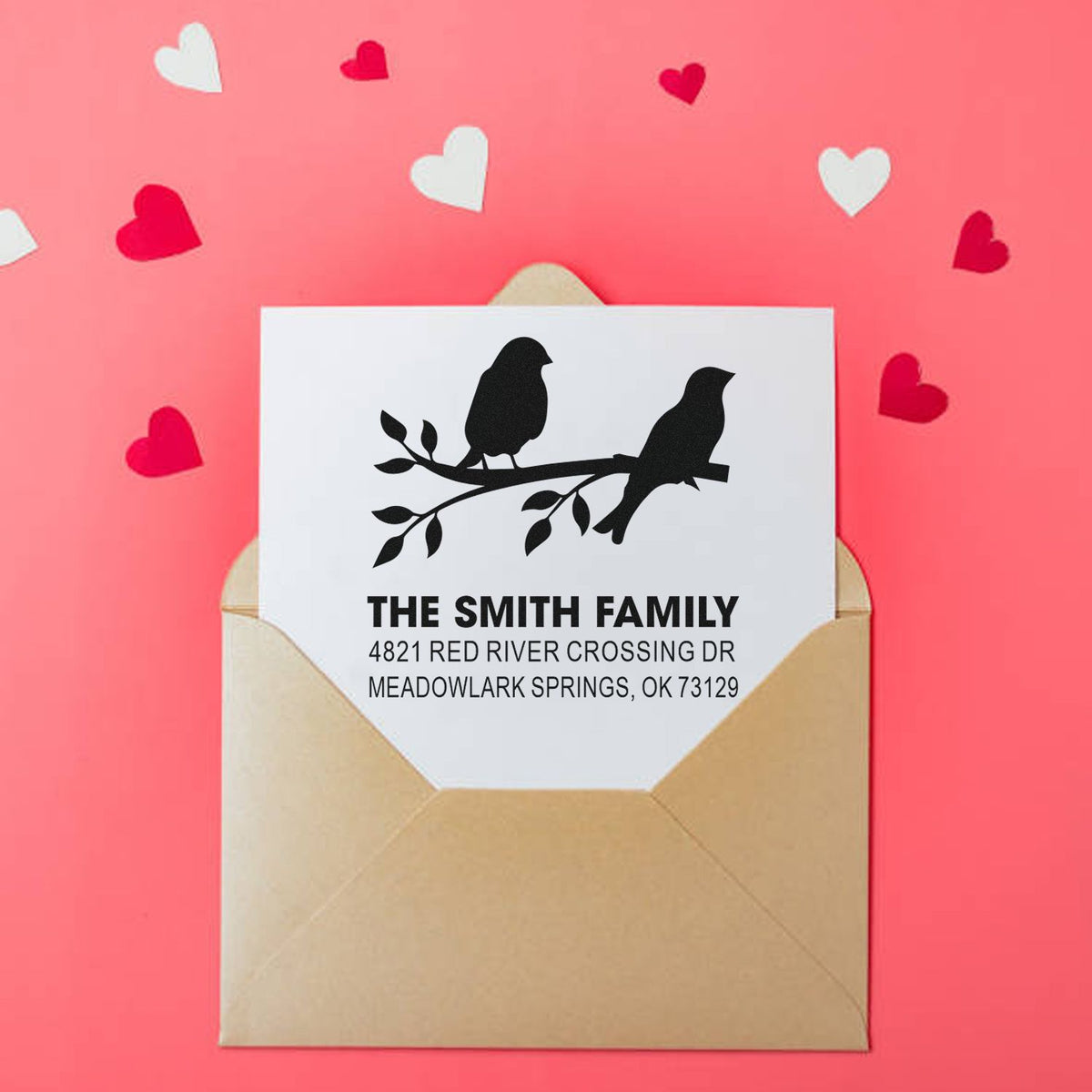 Personalized return address rubber stamp with bird branch design, The Smith Family name and address on an envelope with Valentine hearts.