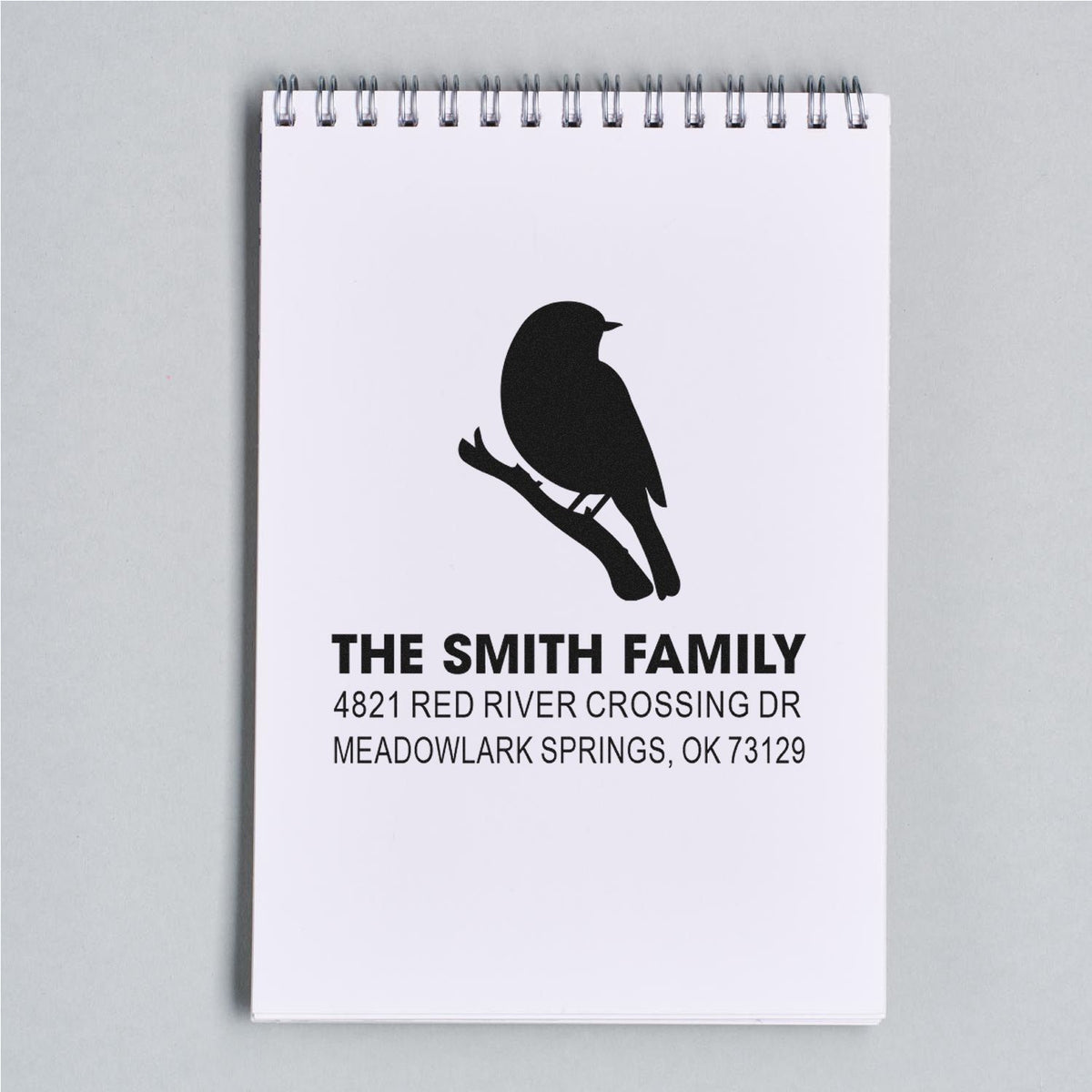 Custom family return address rubber stamp with bird silhouette design, featuring The Smith Family and Meadowlark Springs, OK mailing address on notepad.