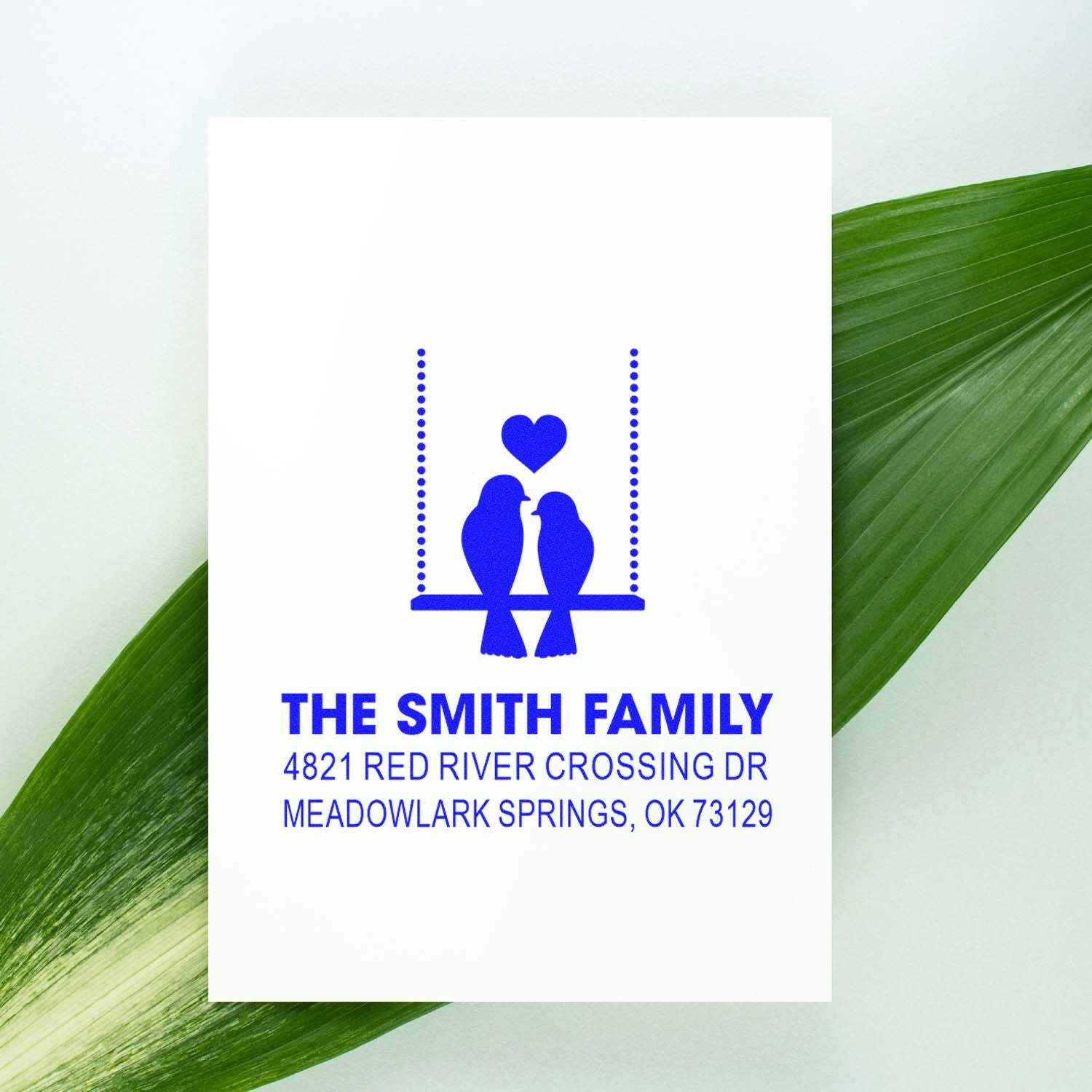 Personalized return address rubber stamp with blue birds on a swing, heart accent, and custom family name and mailing address for envelopes