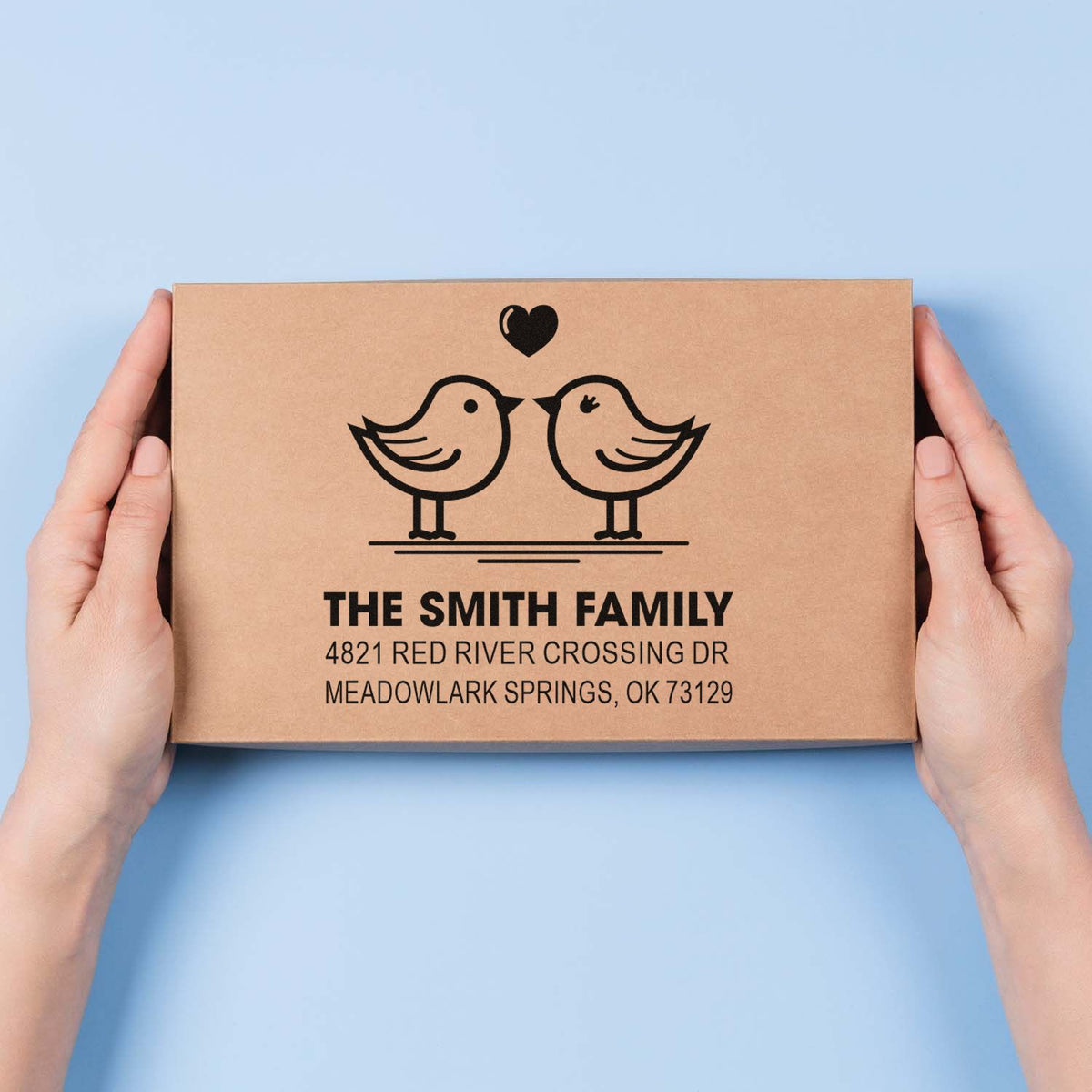 Custom rubber stamp with bird and heart design for The Smith Family, featuring personalized return address for mailing and packaging.