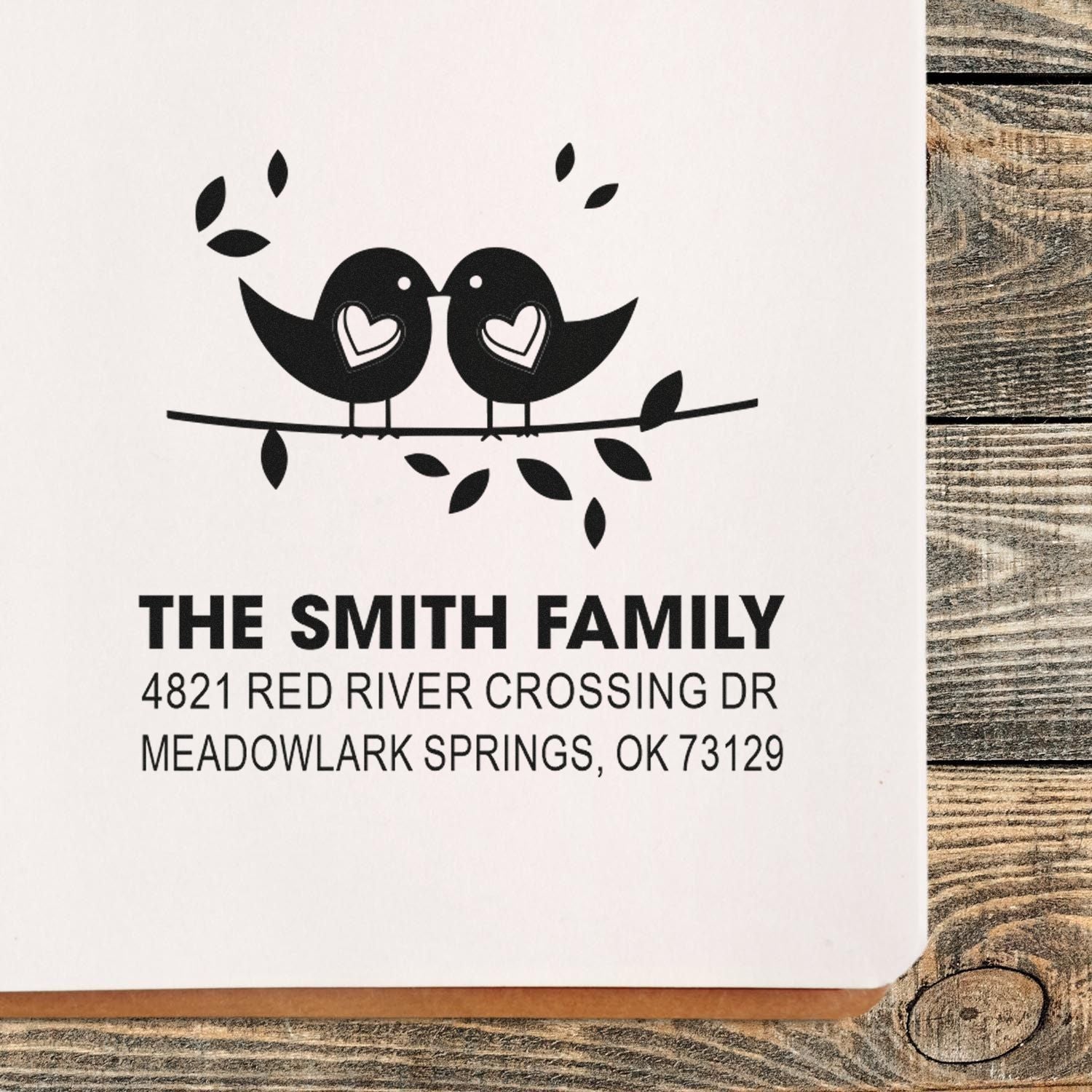 Custom rubber address stamp with two lovebirds on a branch, hearts in wings, The Smith Family name, and Meadowlark Springs, OK return address.