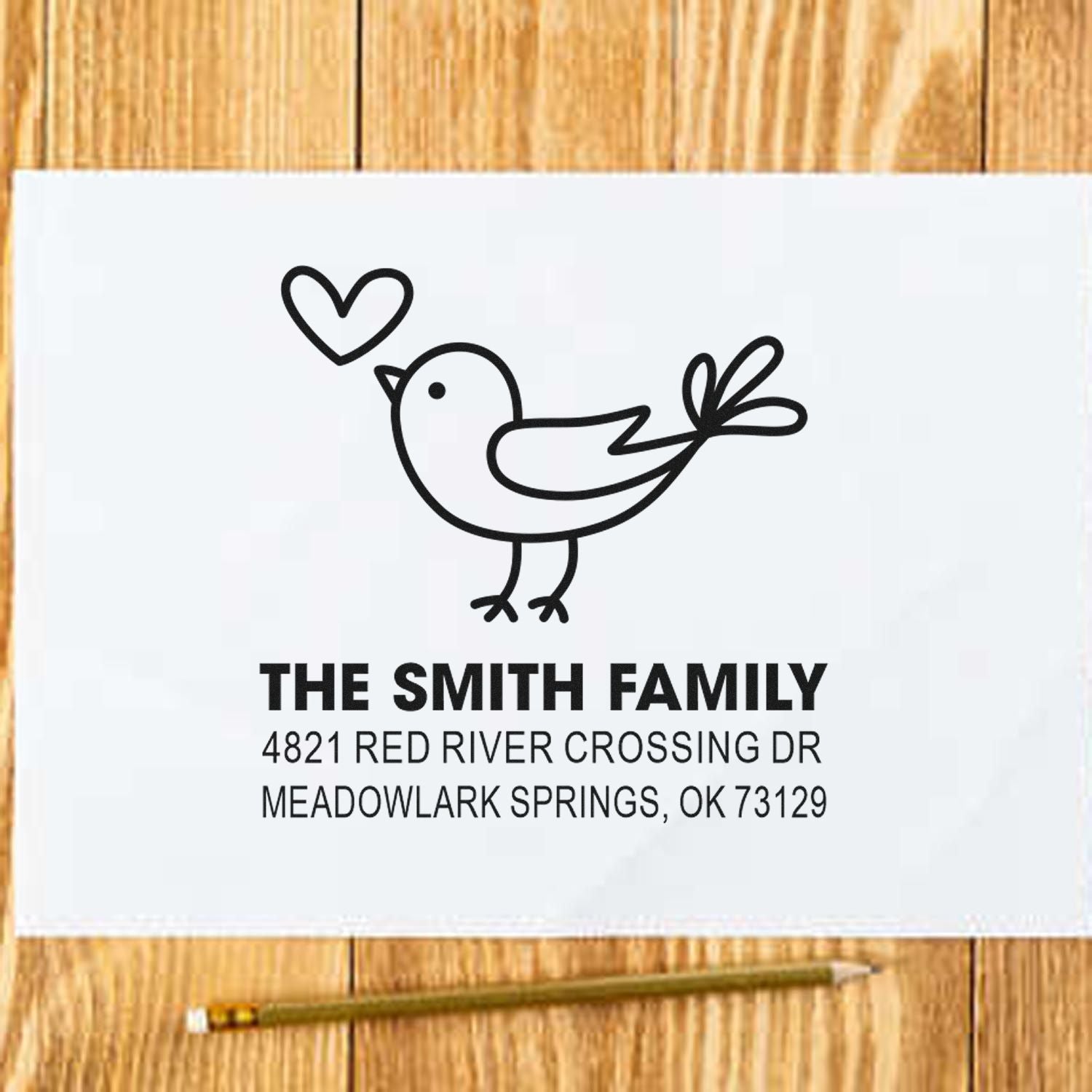 Custom family address rubber stamp with cute bird and heart design, featuring The Smith Family name and mailing address for envelopes.