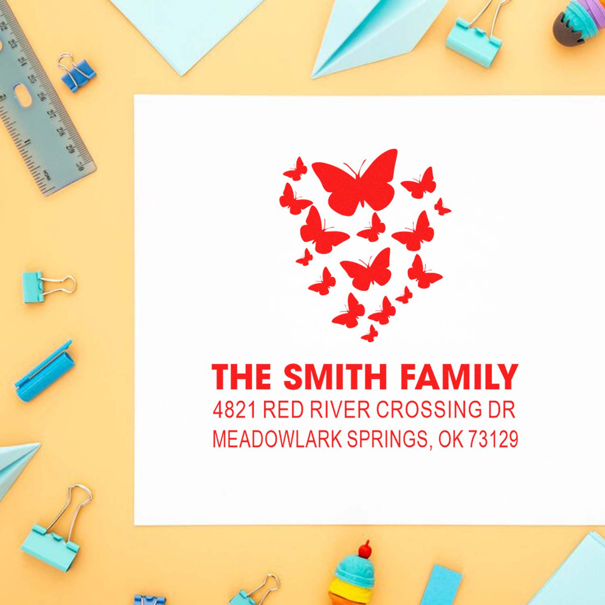 Custom butterfly family return address rubber stamp with The Smith Family name and Meadowlark Springs, OK address on a white card.