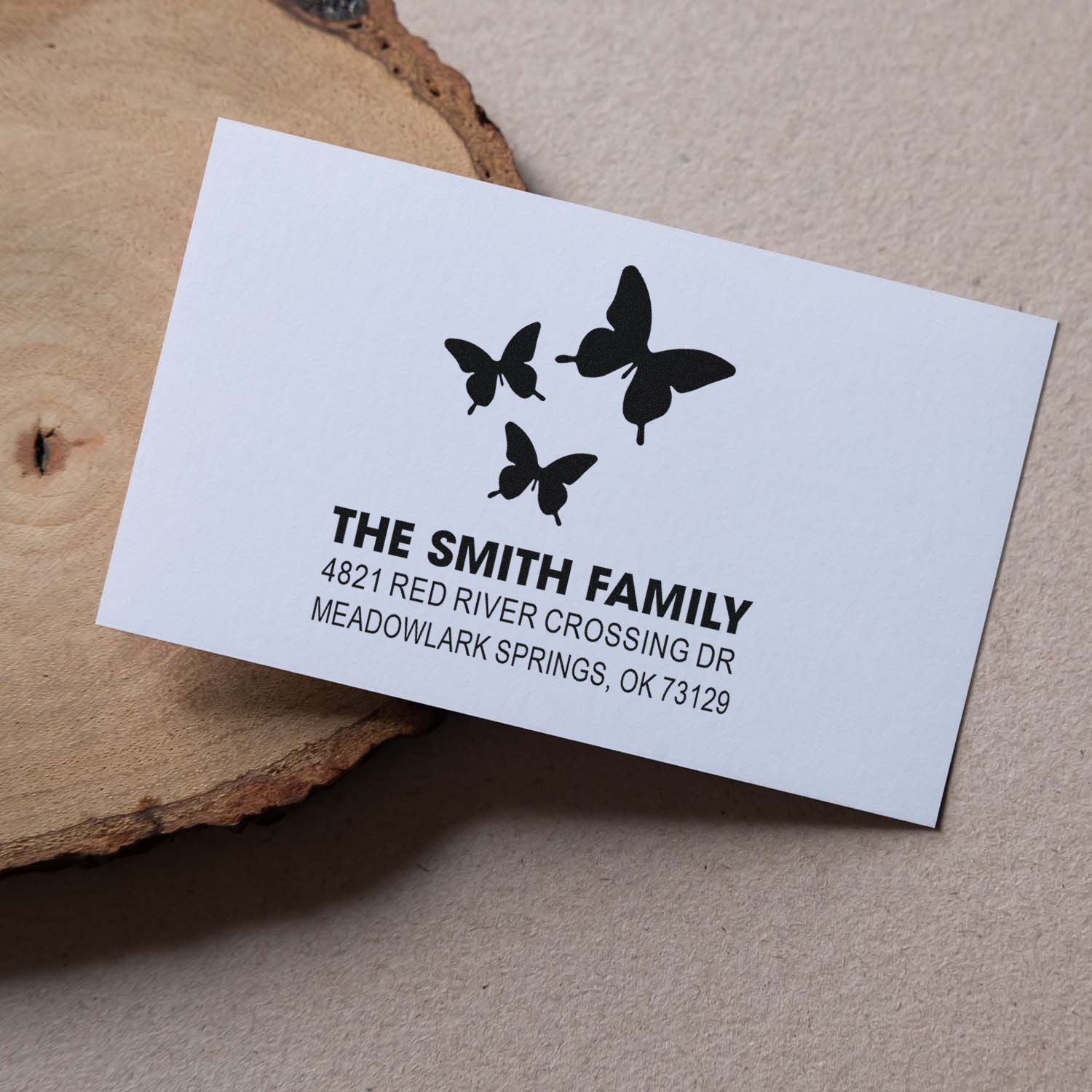 Custom return address rubber stamp with butterfly design for The Smith Family, featuring name and address for envelopes and personalized stationery.