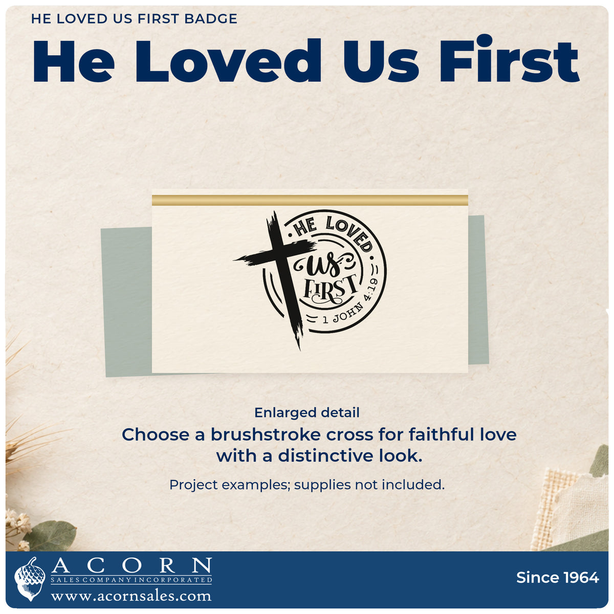 Enlarged detail of the He Loved Us First Badge Wood Handle Stamp imprint. A brushstroke cross overlaps a circular "He loved us first" design with 1 John 4:19.
