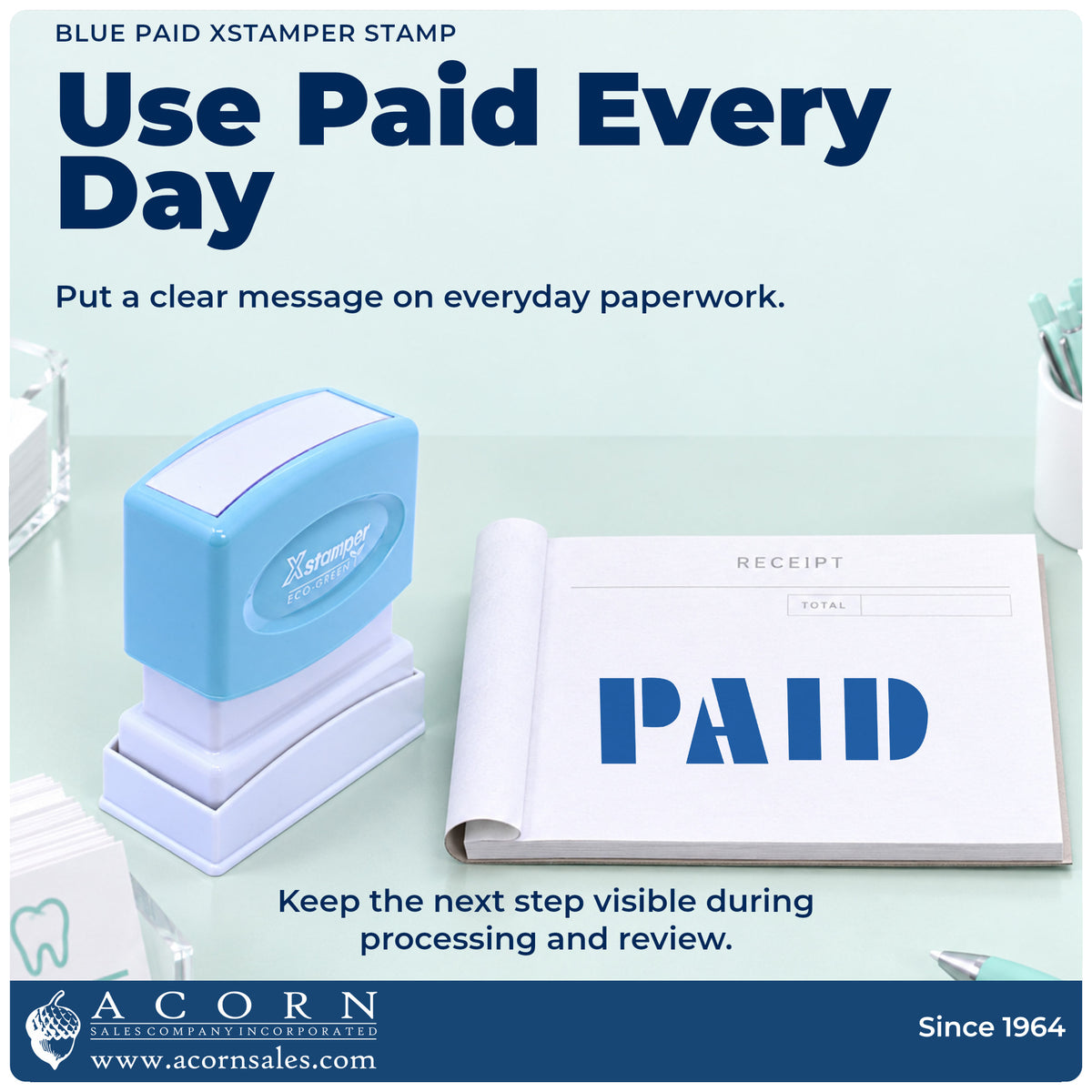 Paid Stamp – Blue Pre-Inked Xstamper being pressed to leave an imprint reading "Paid"