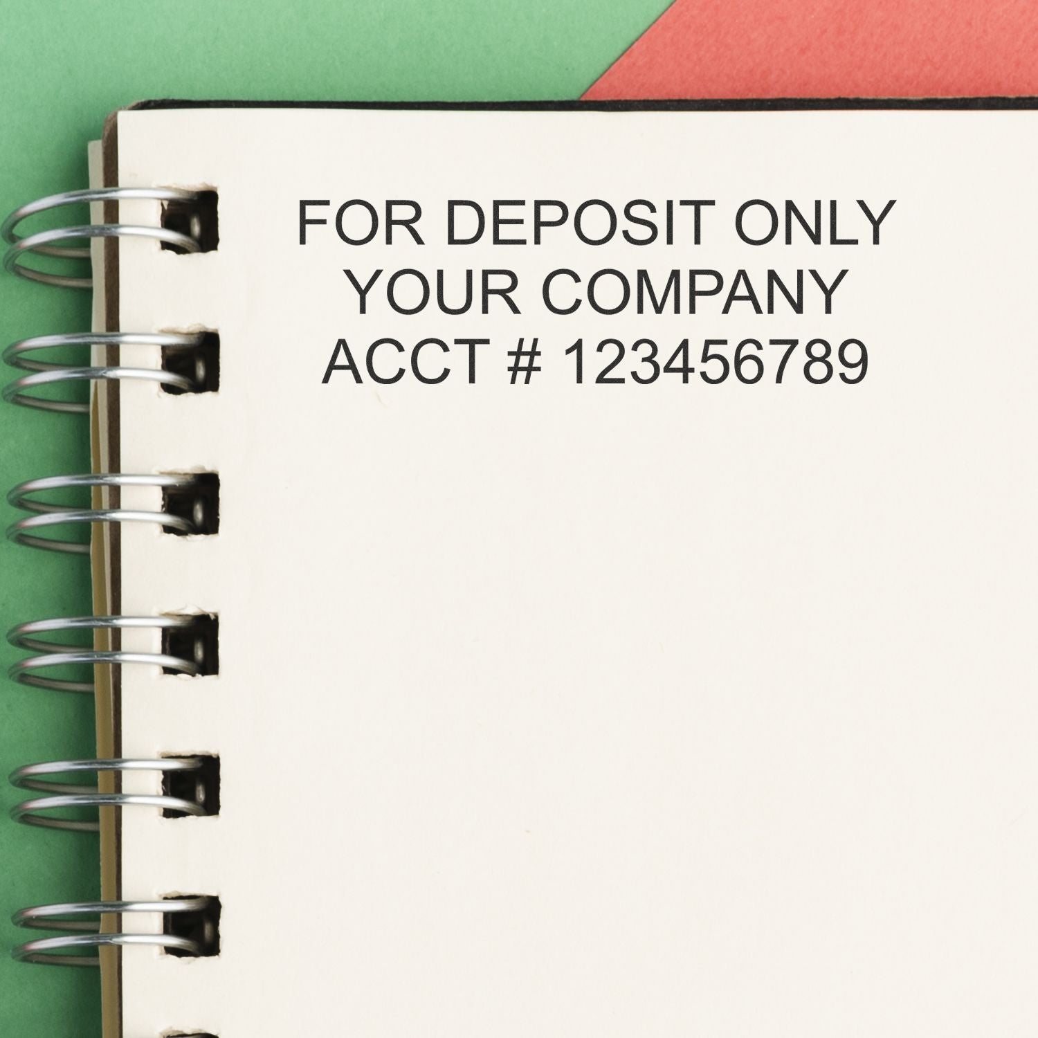 Close-up of spiral notebook page with For Deposit Only company account number text on a colorful background.