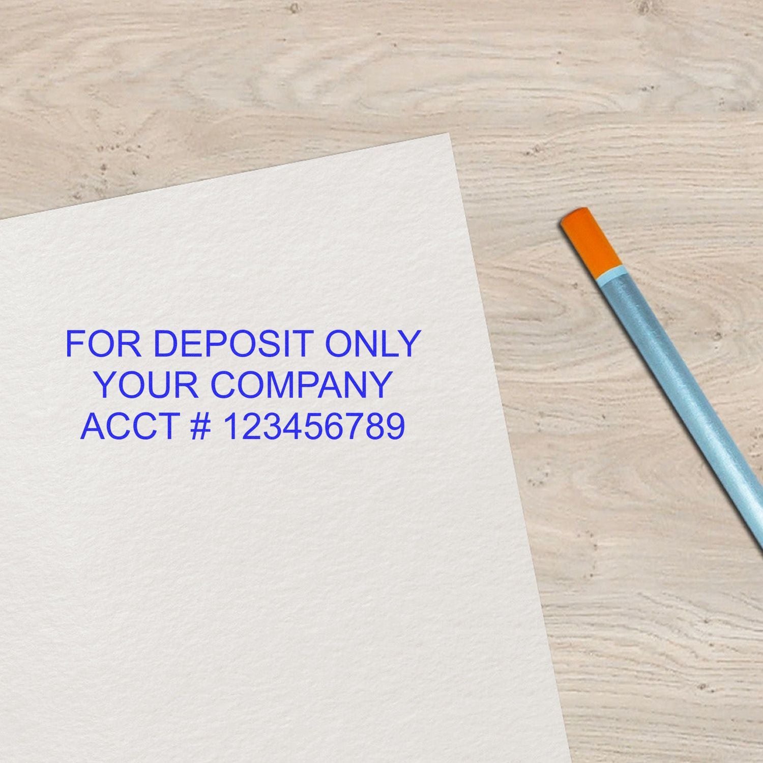 Business deposit-only check with pen on wooden desk.