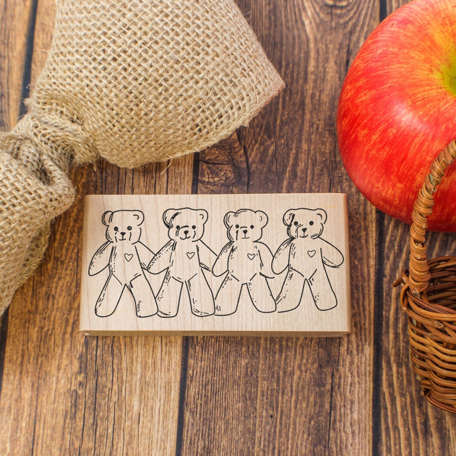 Wooden teddy bear rubber stamp with four cute bears on rustic wood background, perfect for crafting and DIY projects.