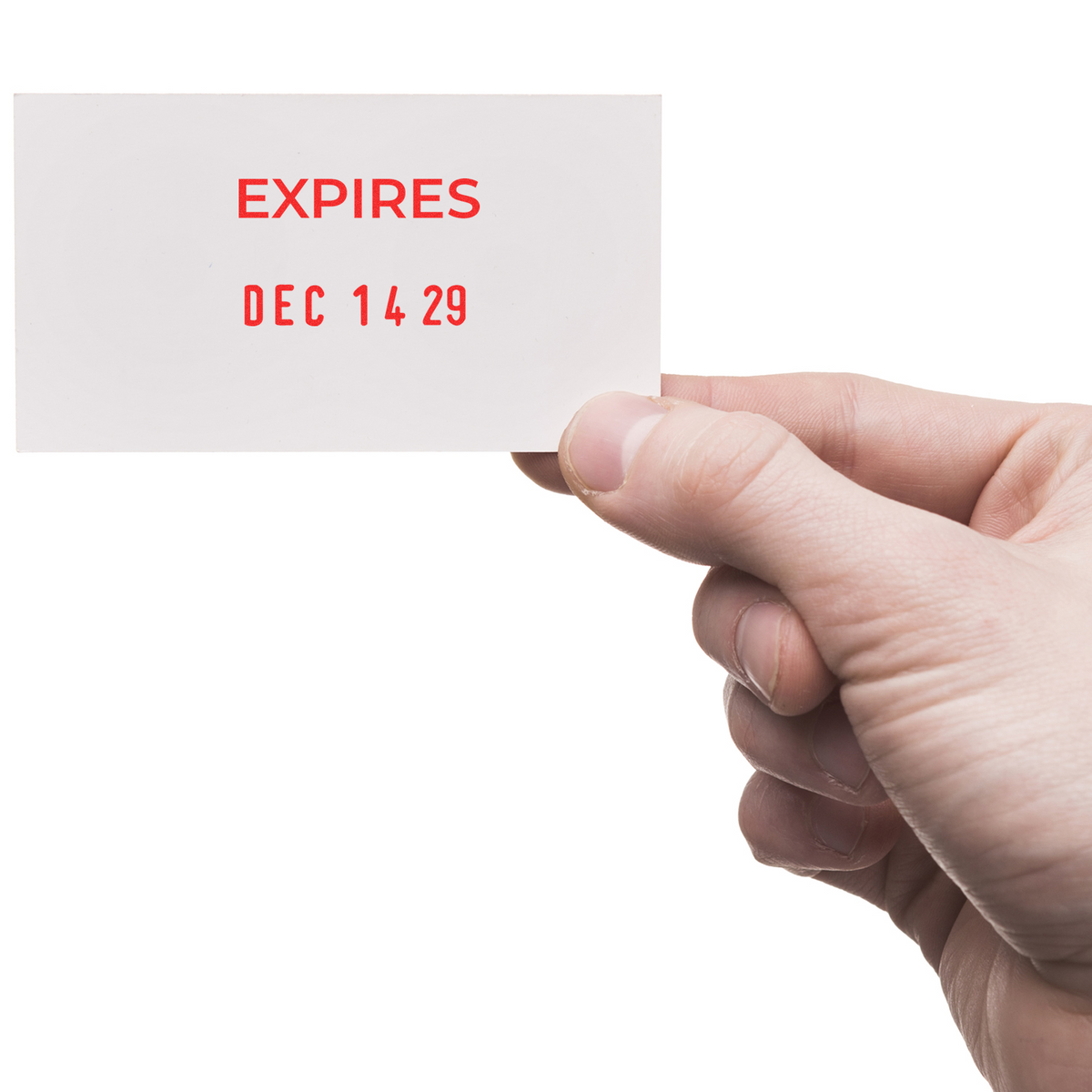 Hand holding white expiration card with red EXPIRES DEC 14 29 text on a white background.