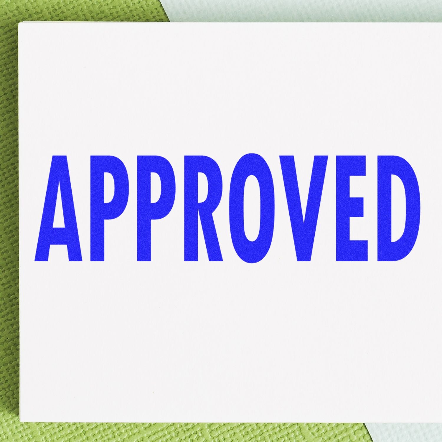 Bold blue APPROVED text on a card over a green background, indicating approval, acceptance, and quality control status.