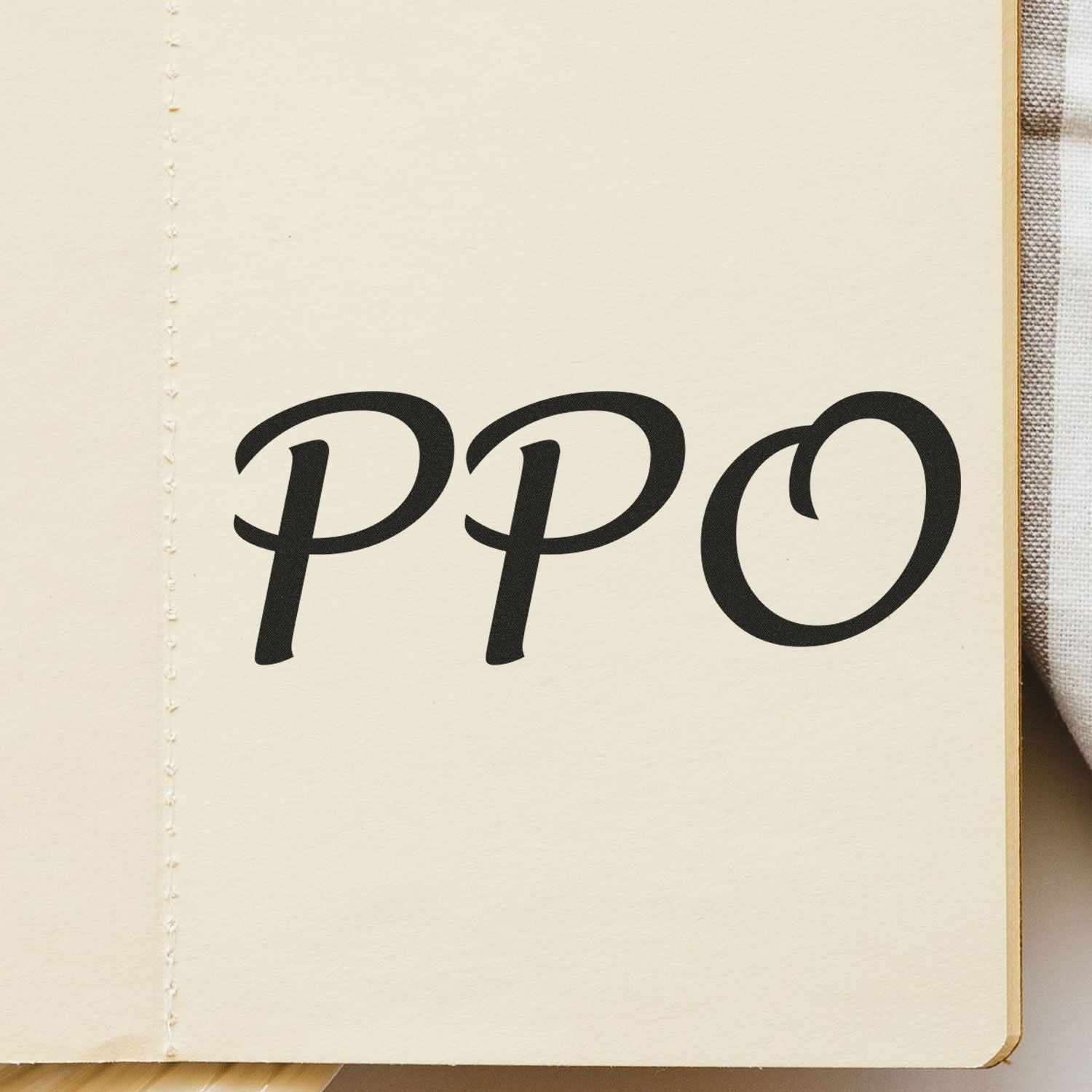 PPO logo printed on an off-white notebook cover, showcasing brand identity for stationery and office supplies