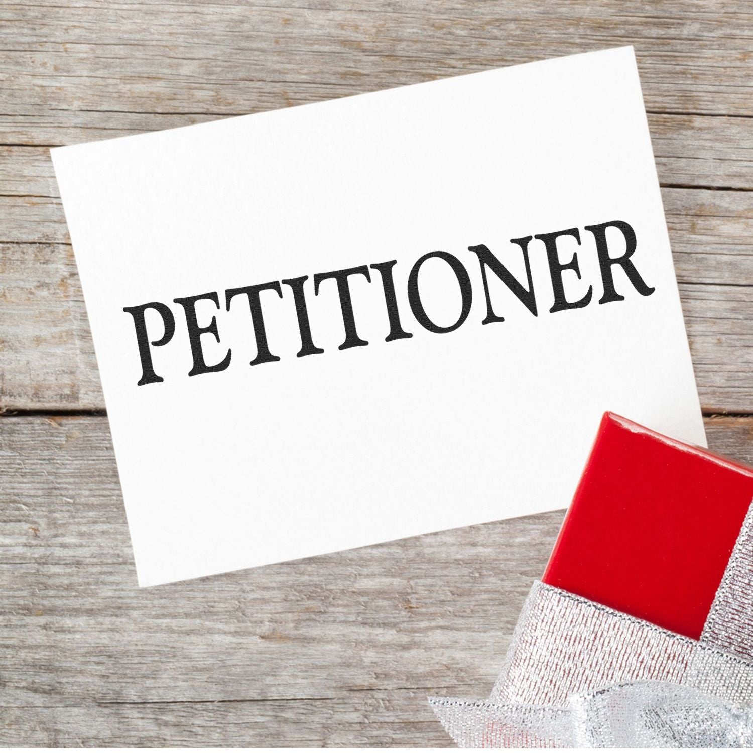 Petition sign-up card with PETITION text on wooden table, suggesting advocacy, activism, and community support