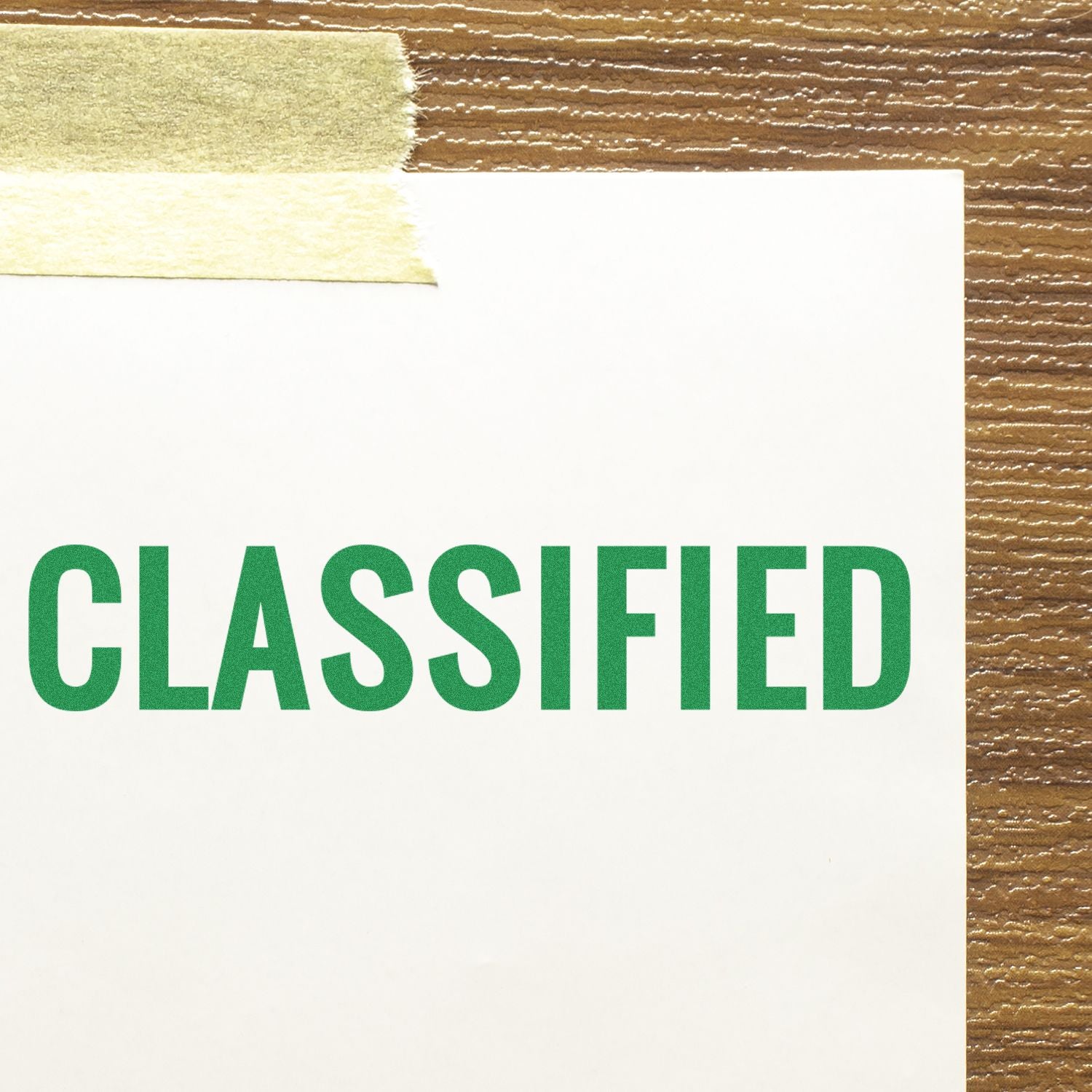 Close-up of a CLASSIFIED stamped label on white paper with a brown striped background, for confidential document branding