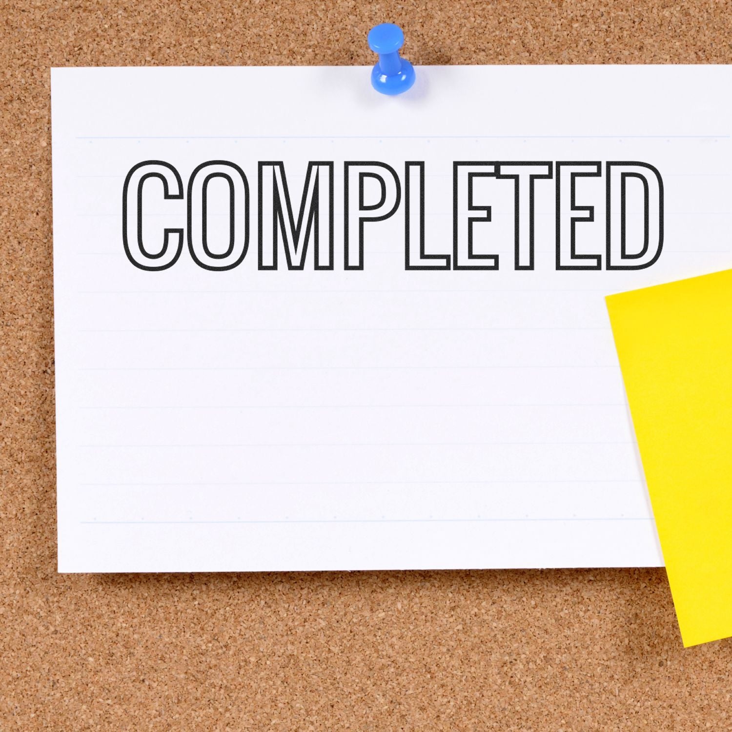 Completed task status on pinned note over cork board, showing a project is finished and ready for next steps in workflow today.