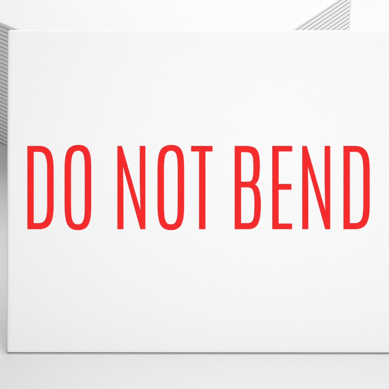 Do not bend warning text on white shipping package indicating careful handling for durable delivery.